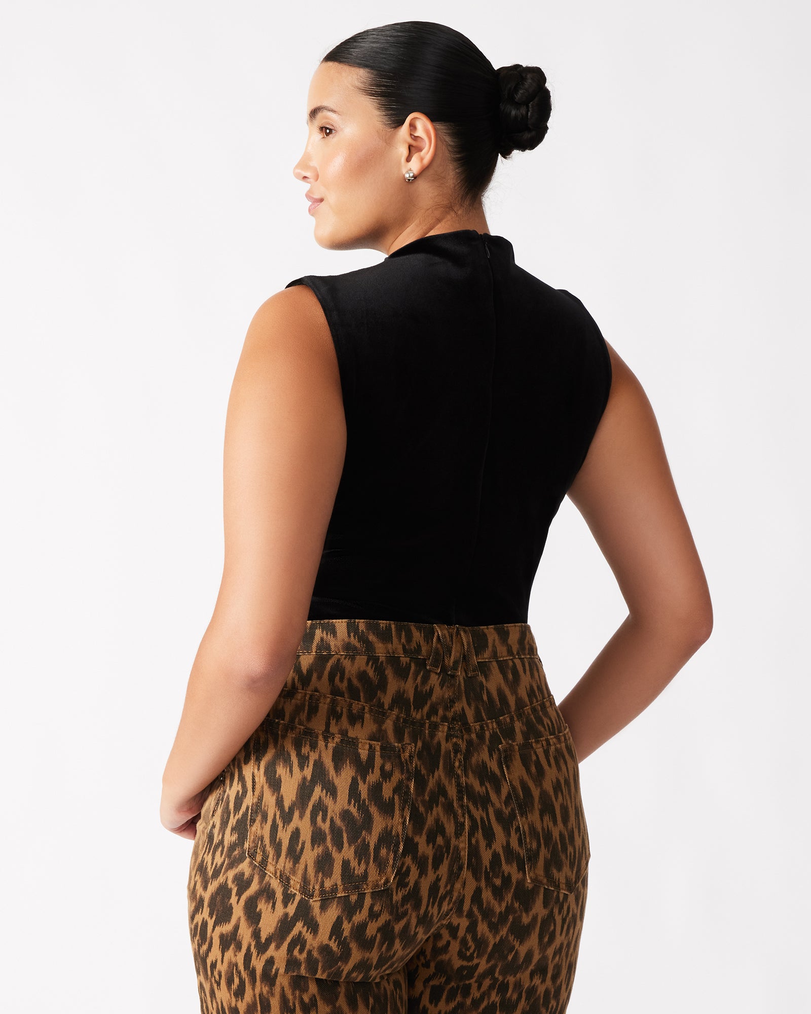 Close-up of the black velvet bodysuit showcasing the mock neck design.