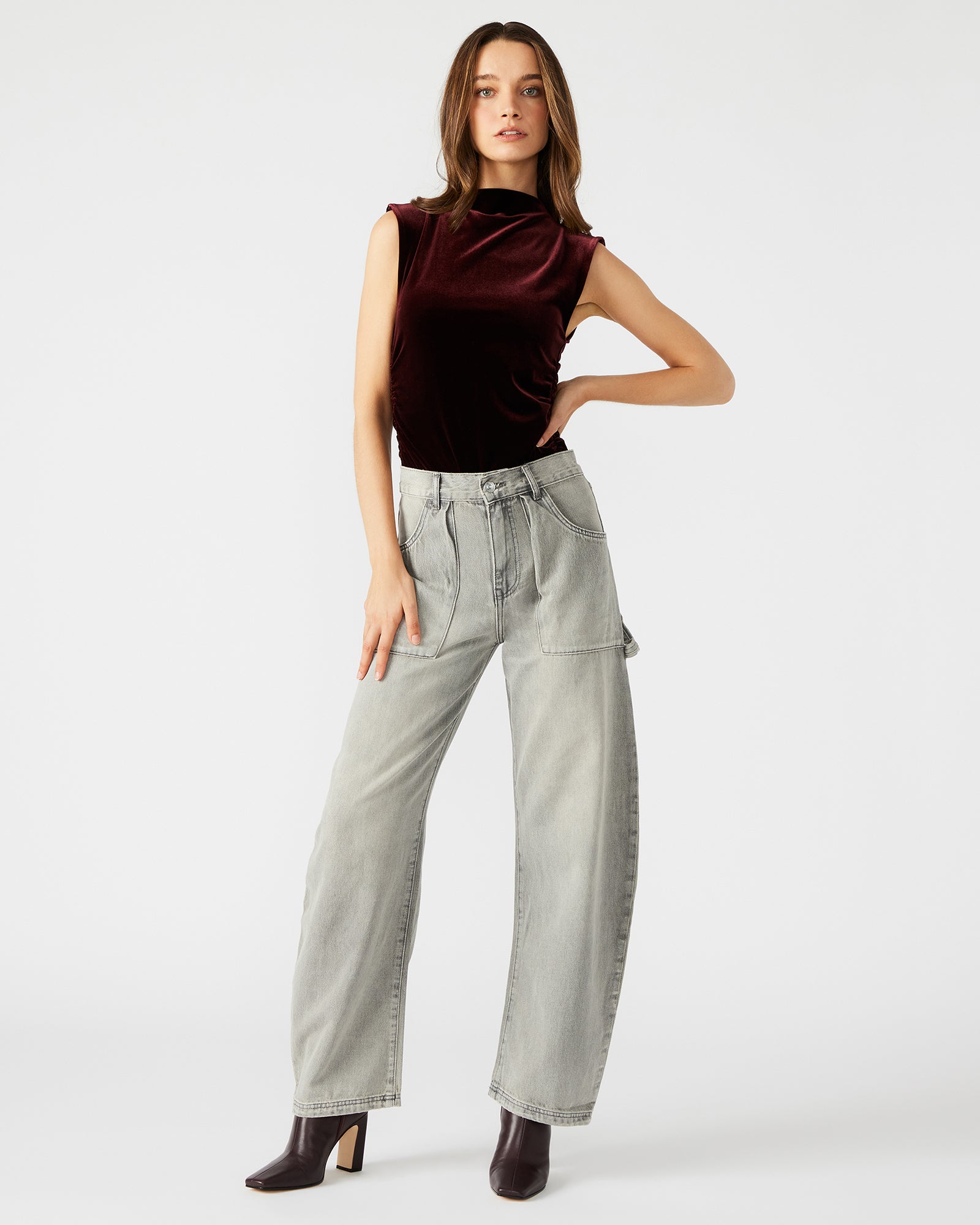 Front view of the sleek velvet mock neck bodysuit in wine.