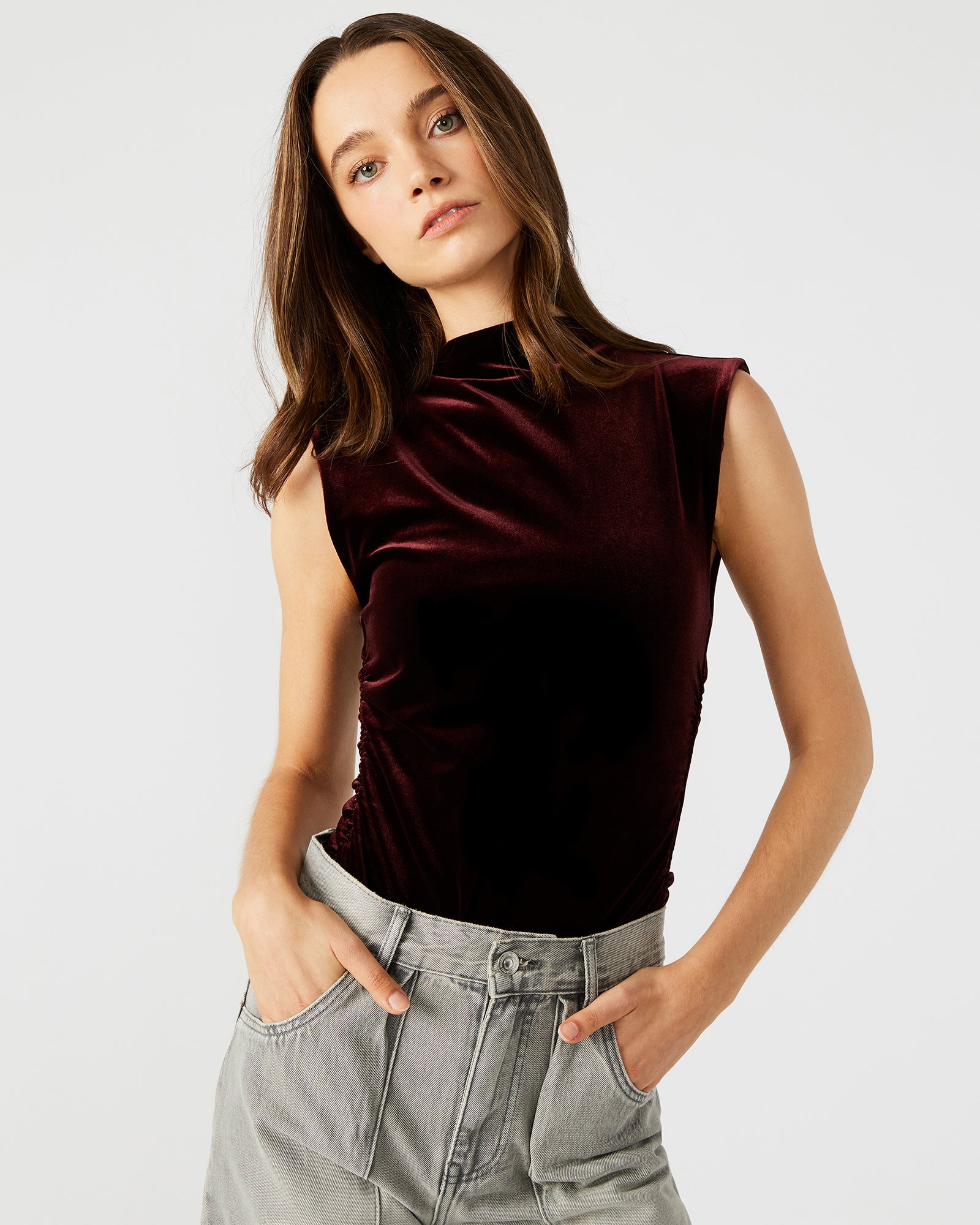 Front view of the sleek velvet mock neck bodysuit in wine.