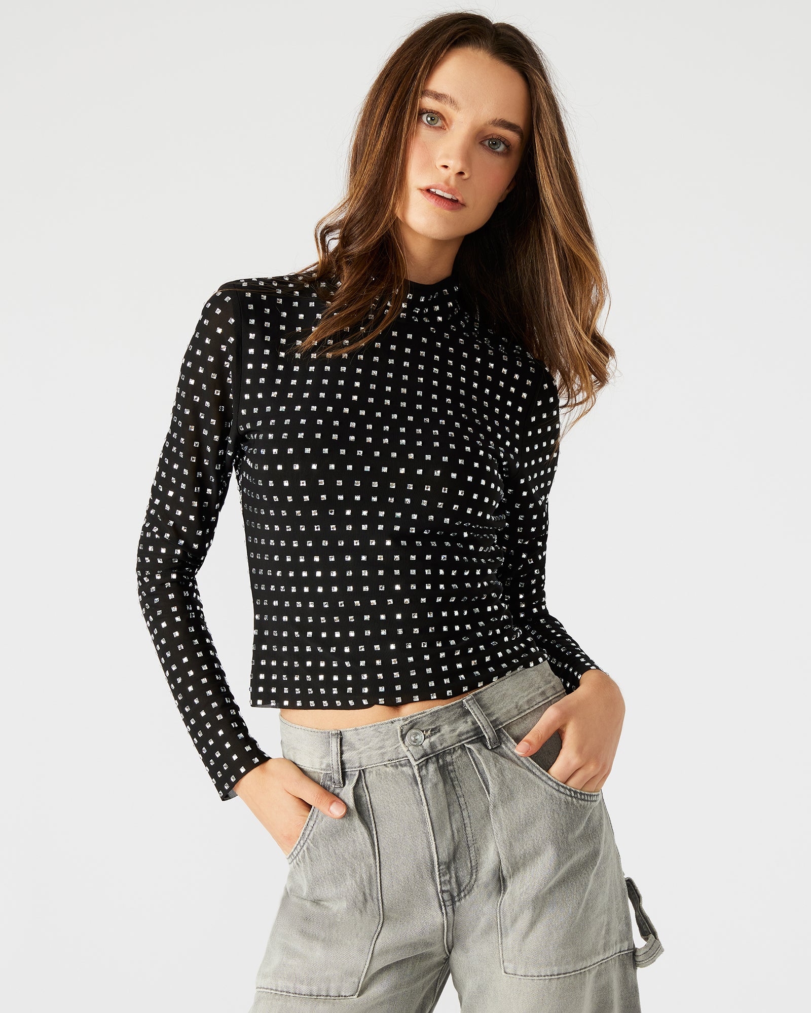 Side view of the long sleeve crop top highlighting the sheer mesh fabric.