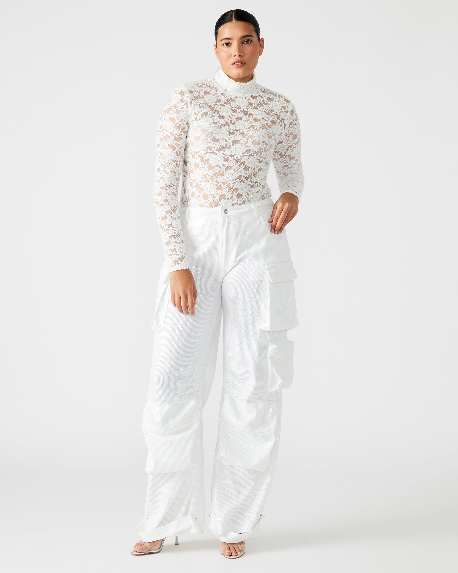 Back detail of long sleeve lace bodysuit with snap closure, photographed outdoors.