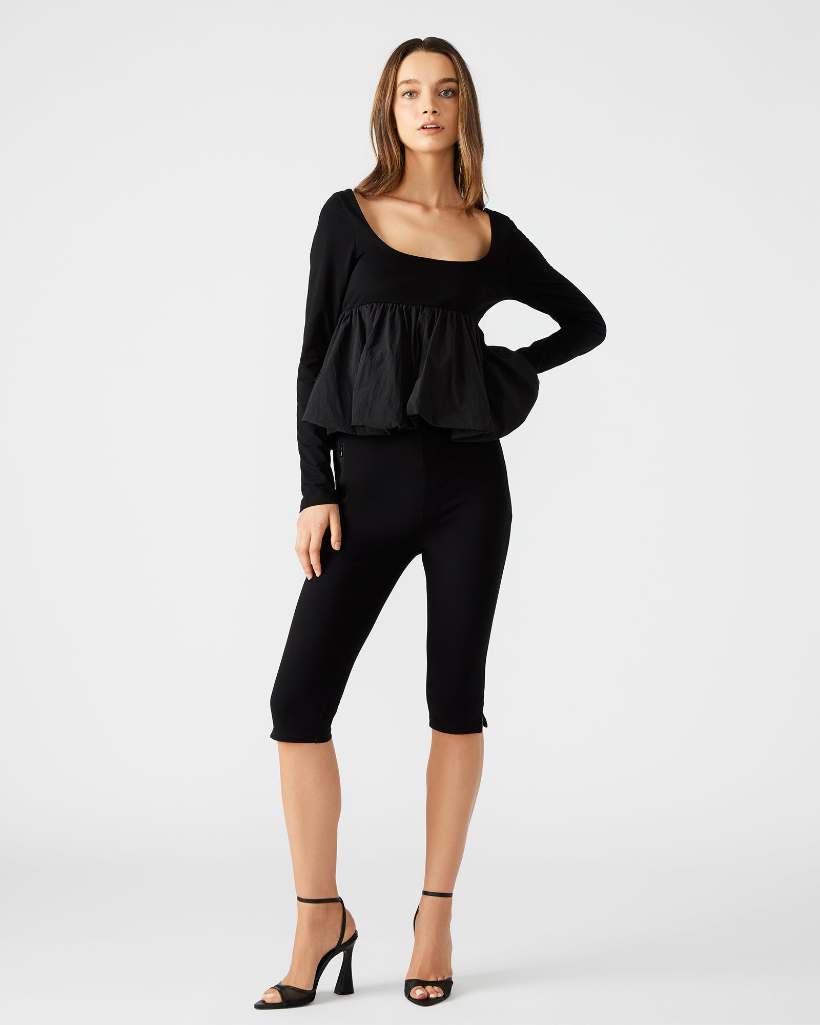 Close-up of the back zip closure on the womens peplum top