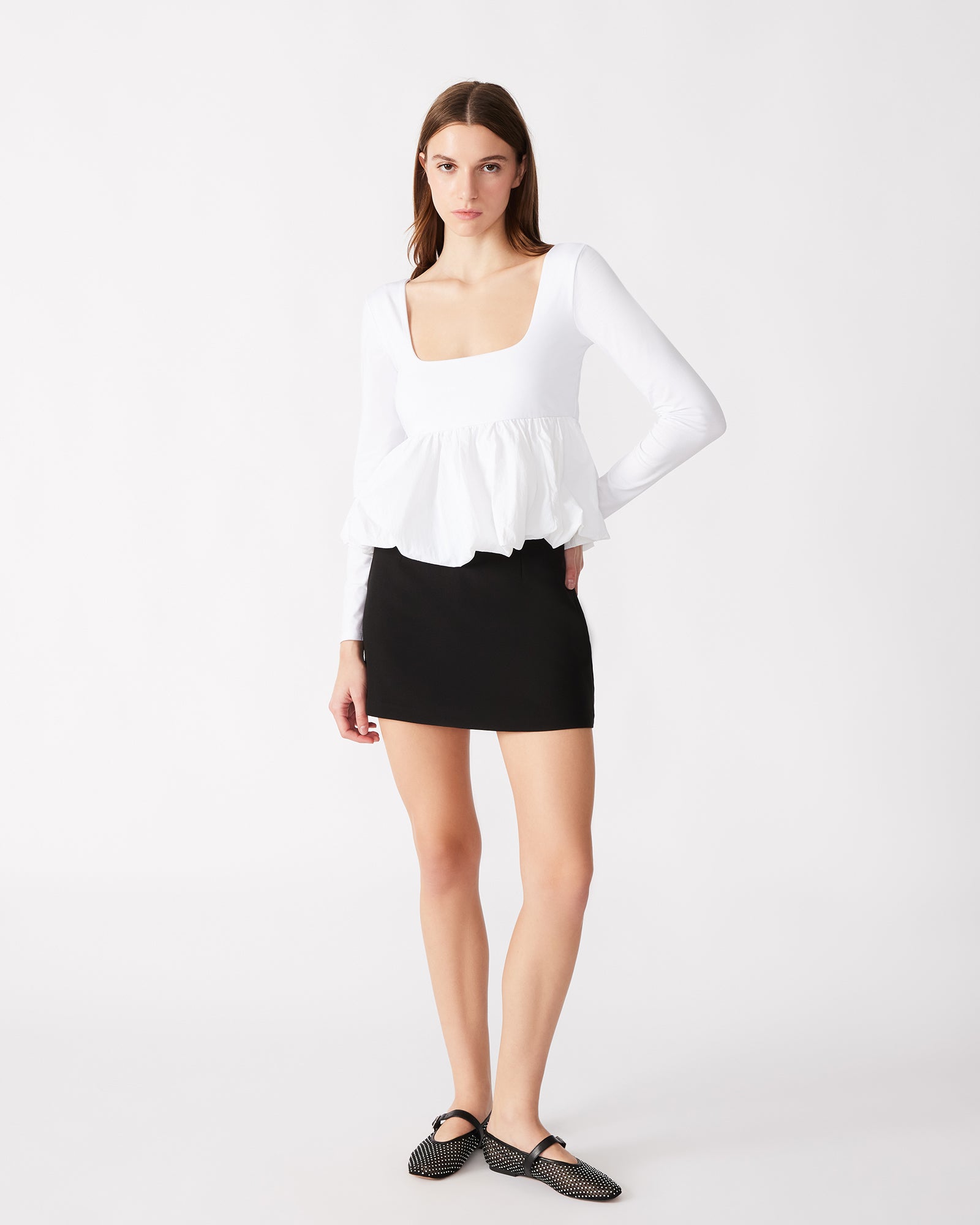 Close-up of the lace long sleeve top with peplum detail on a model