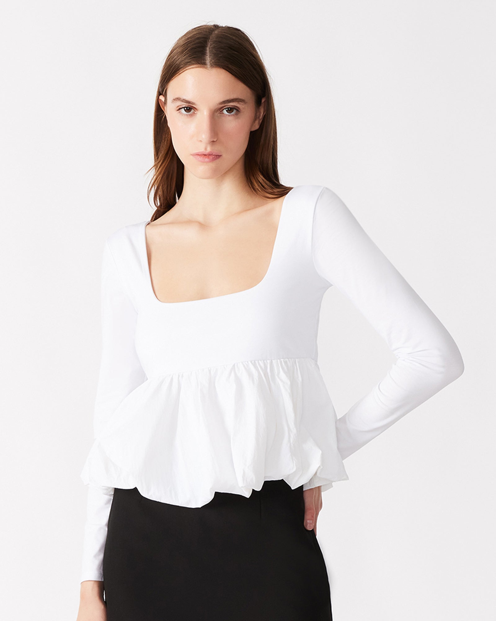 Close-up of the lace long sleeve top with peplum detail on a model