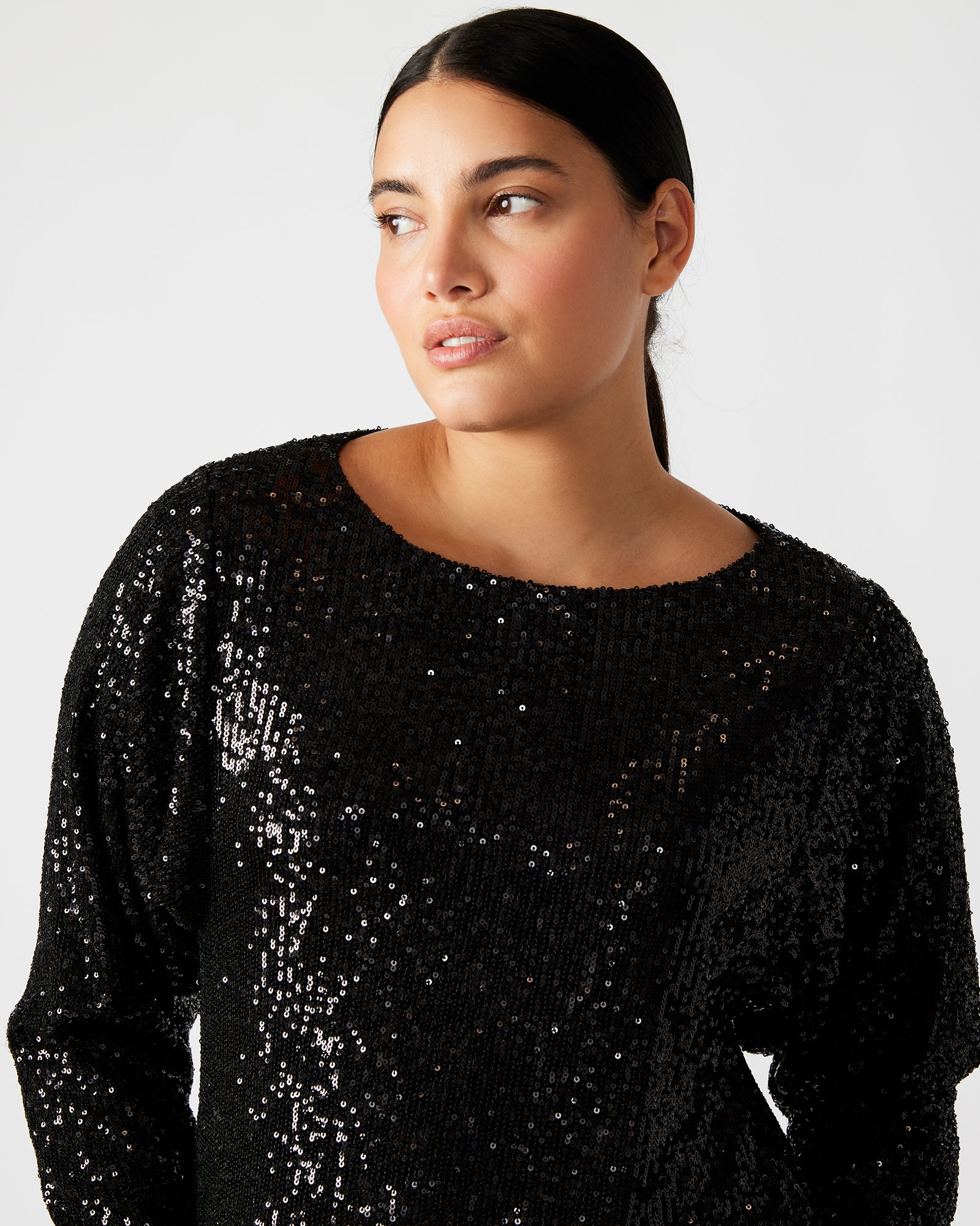 Model wearing the long sleeve sequin mini dress at a night event