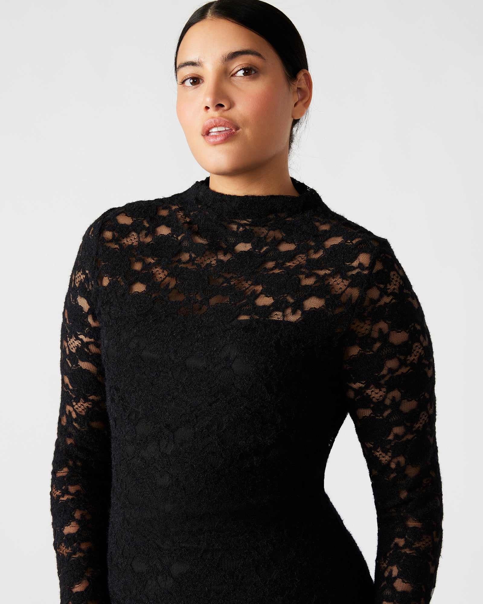 Side angle showing lace dress silhouette and thumbhole sleeve detail