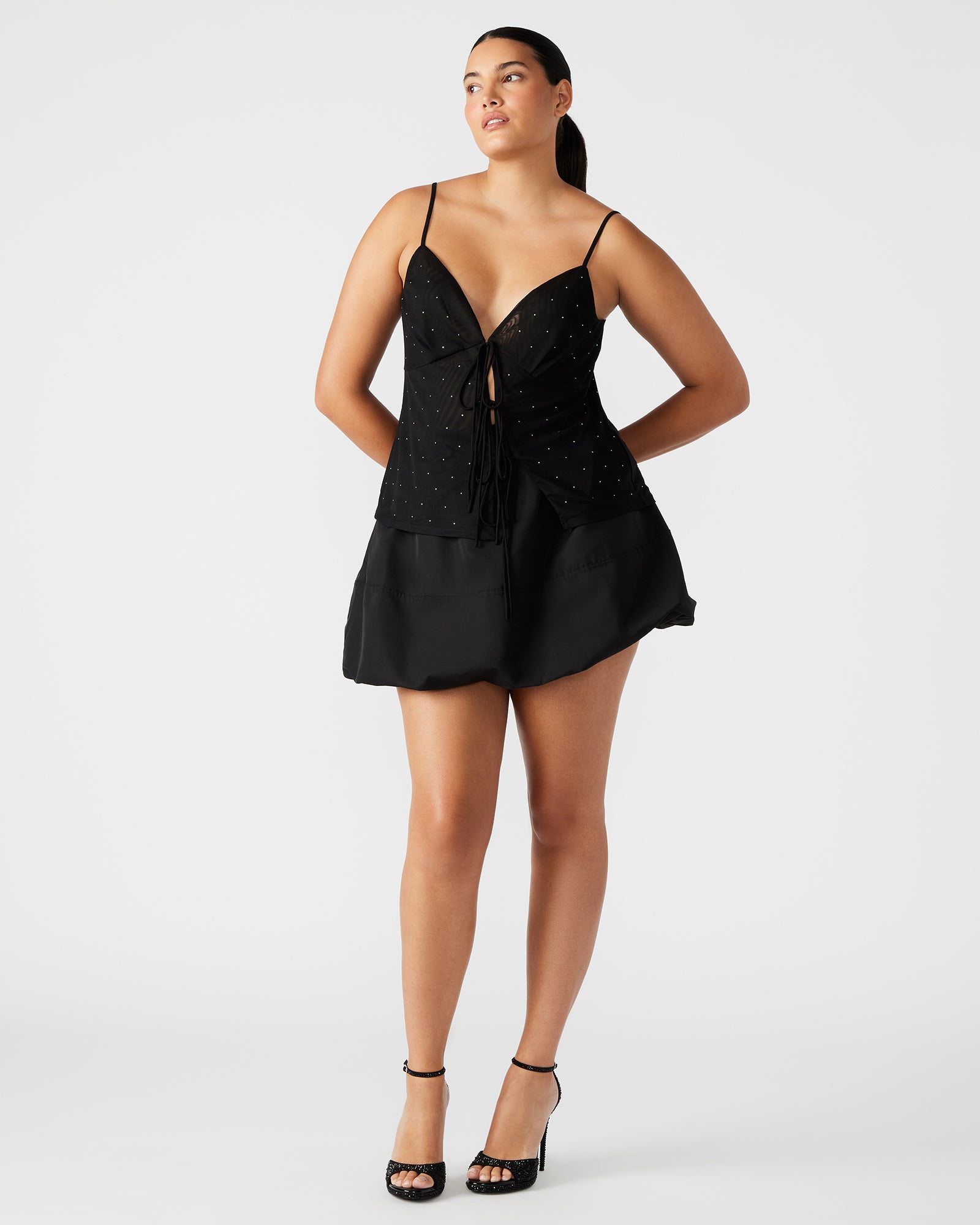 Side view of the black mini skirt, highlighting the zipper closure.