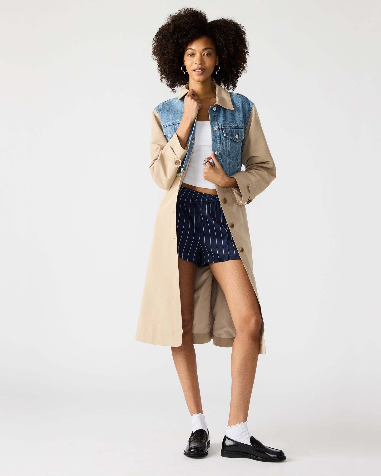 Model walking through Manhattan in denim chore coat with vintage structure.