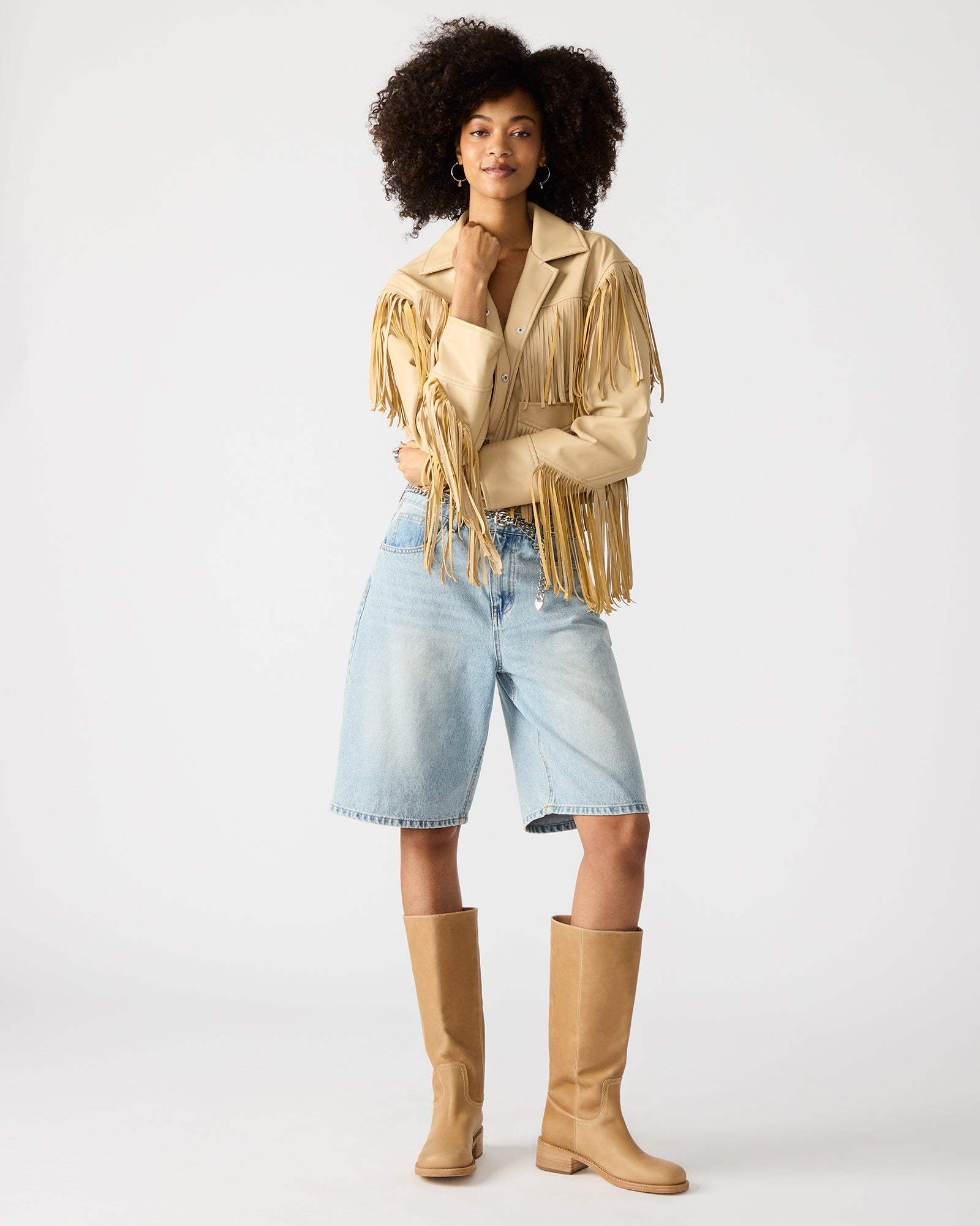 Back view showcasing long fringe flowing from shoulders on Western style sports jacket.