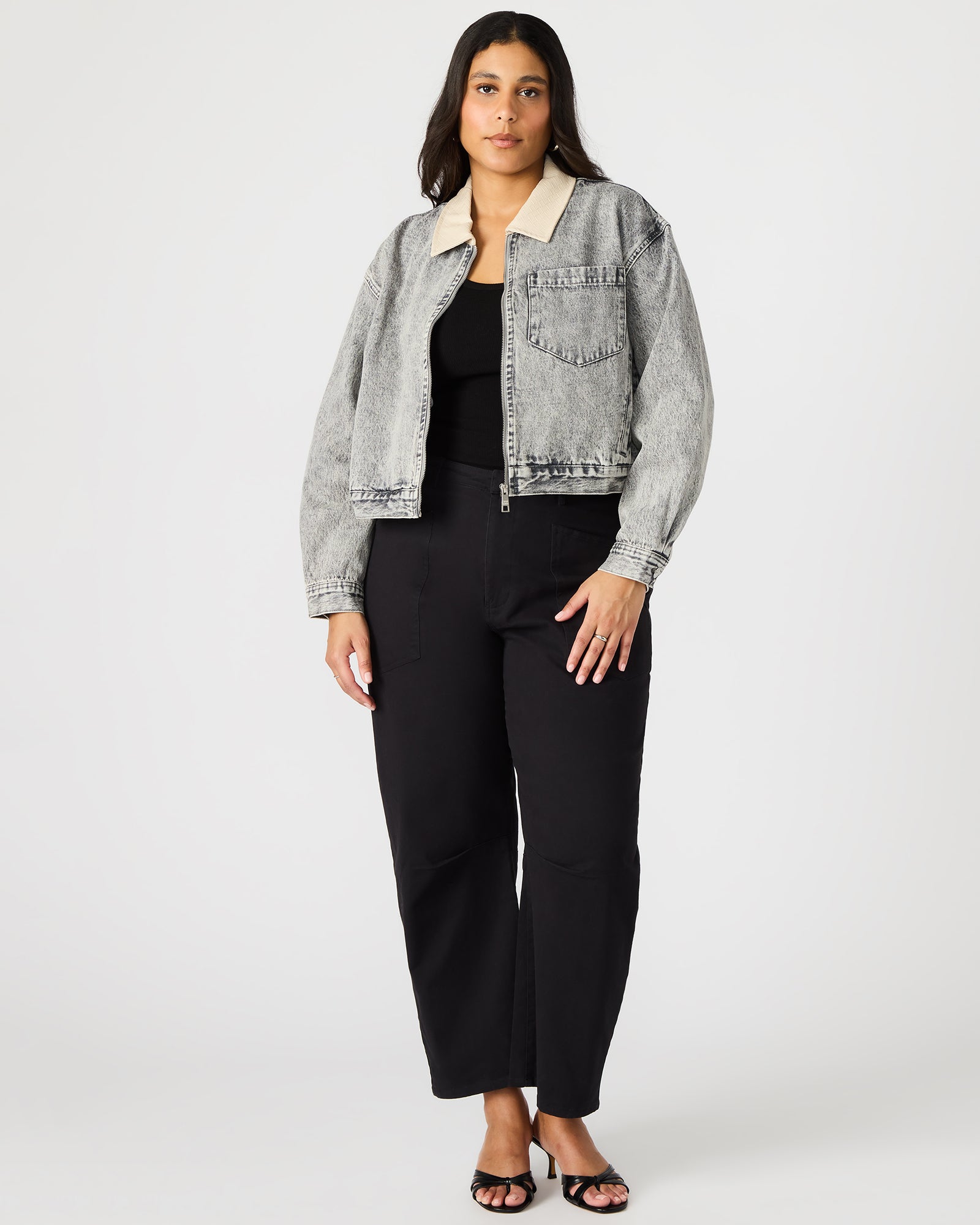Side view showcasing the collared design of the oversized denim jacket.