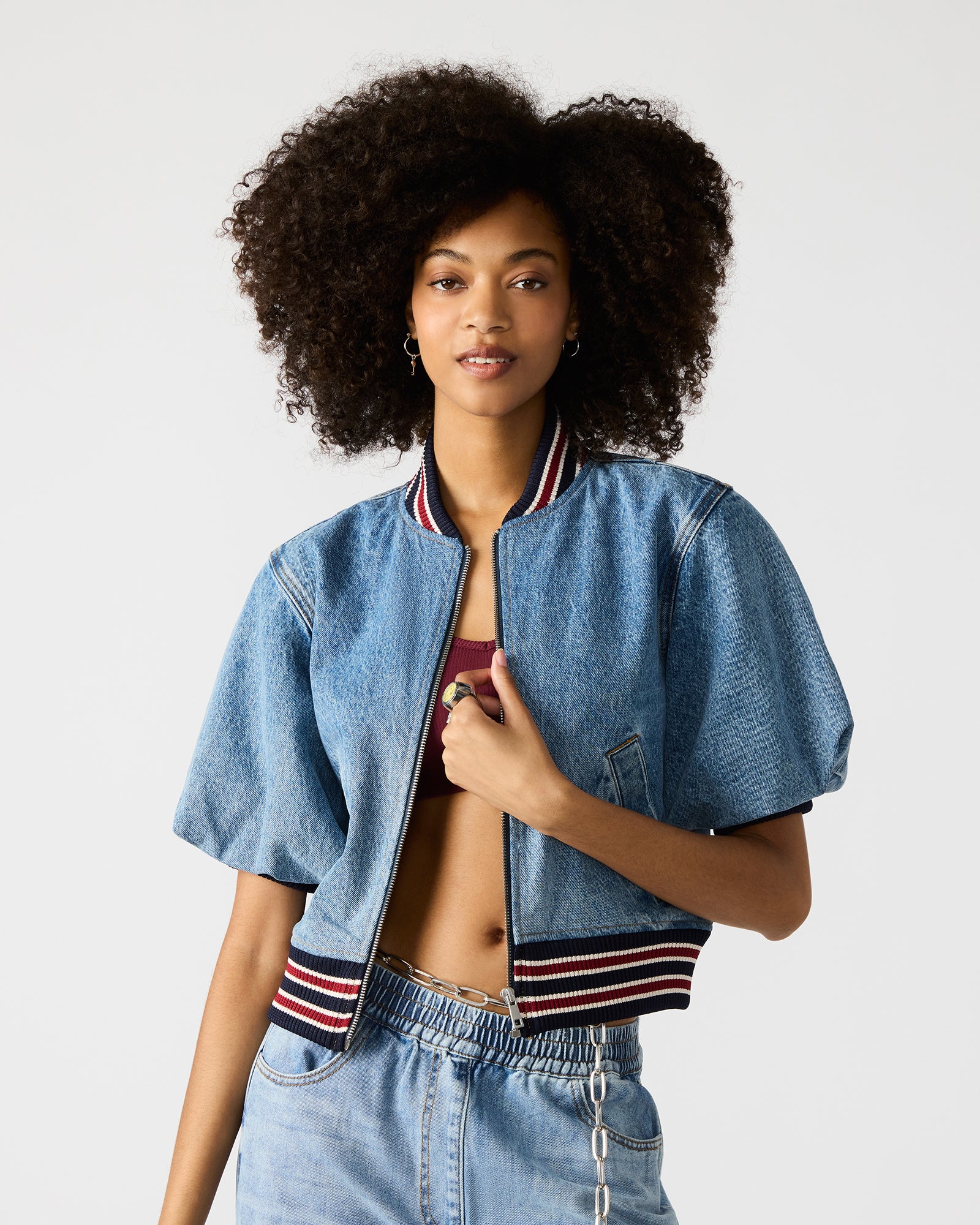 Back detail of zip-up jacket and denim texture shown in natural light