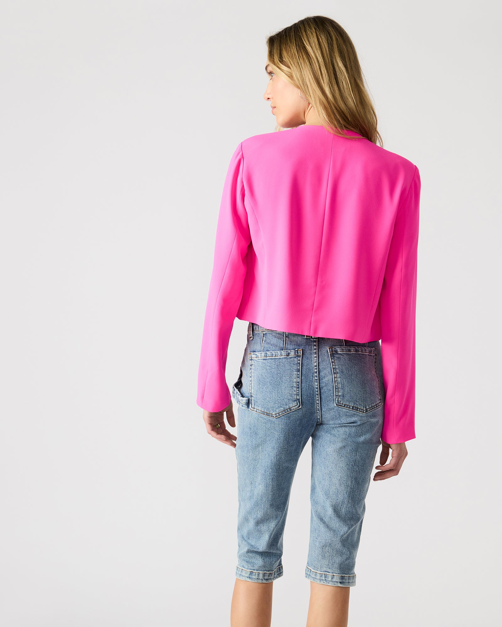 Front and back view of the open-front blazer styled casually with jeans