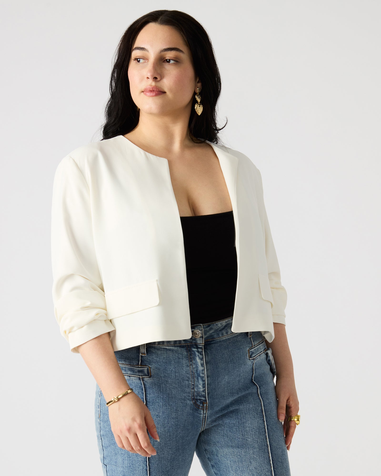 Side view of the womens blazer highlighting the long sleeves and pockets.