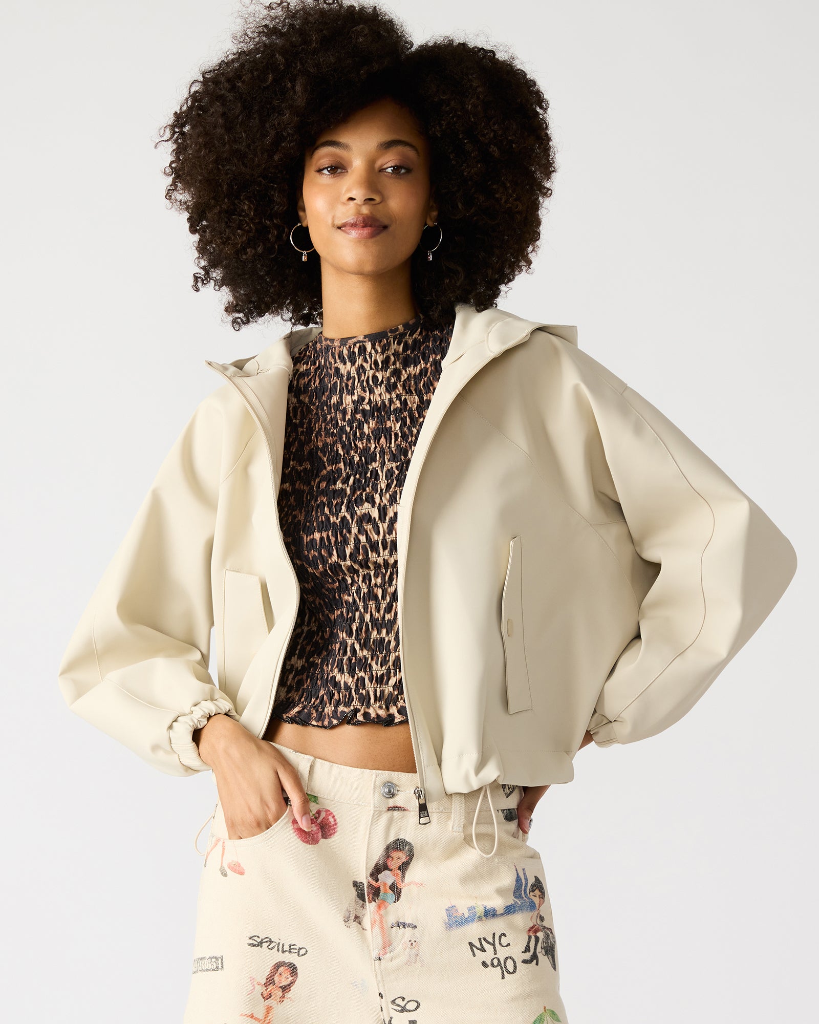 Front view of bone faux leather hooded jacket with zip closure