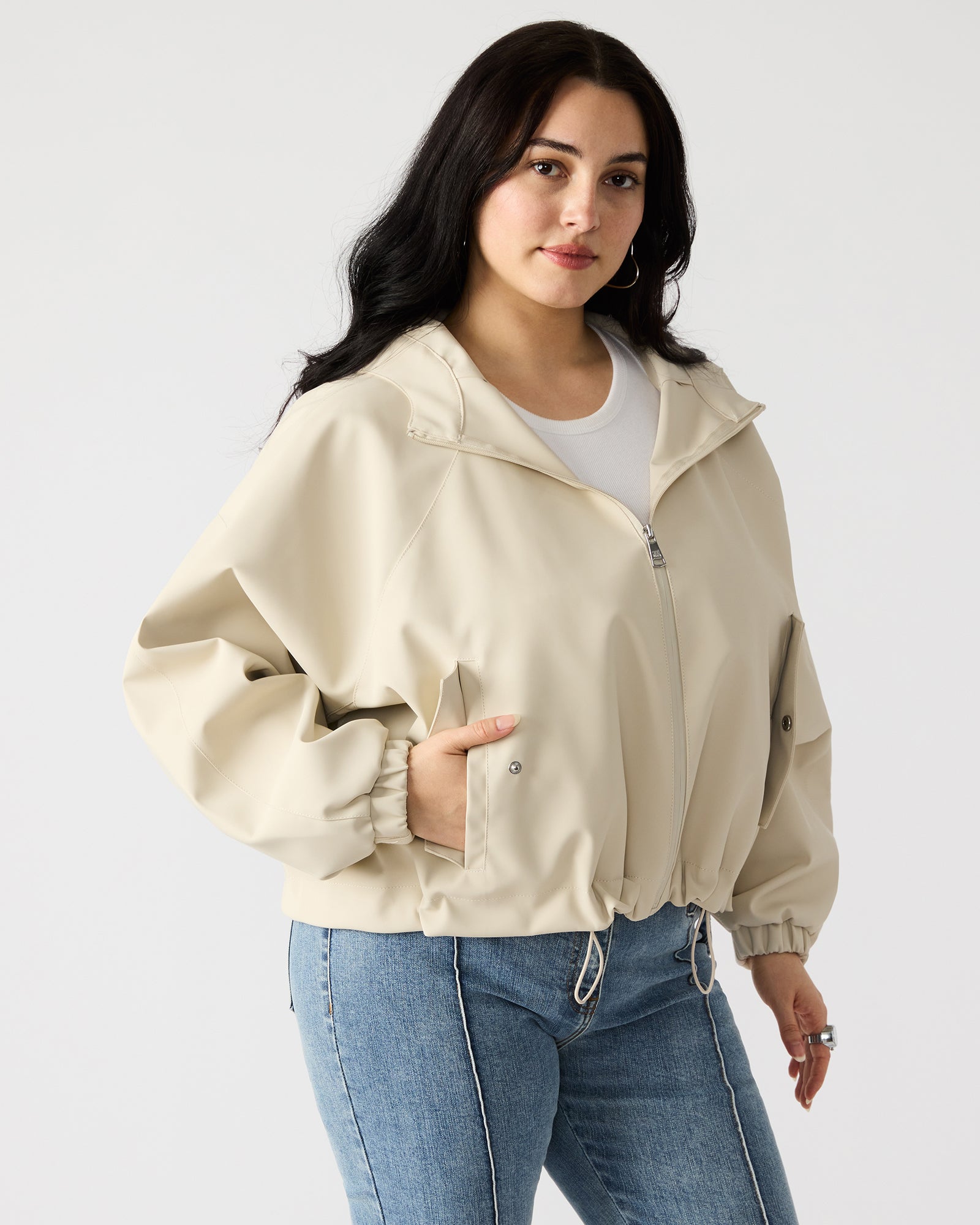 Side angle showing pockets and hood detail on outdoor jacket