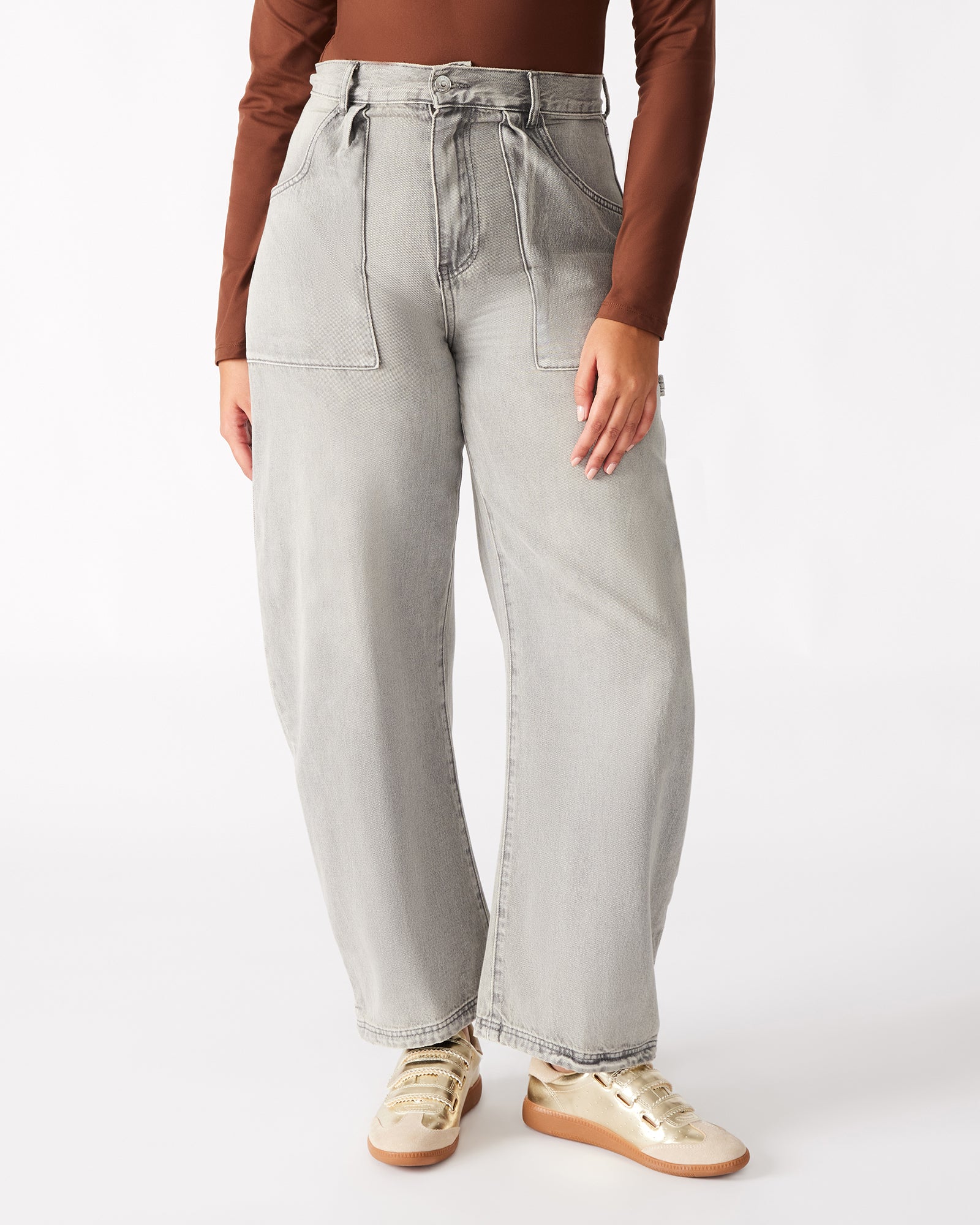 Close-up of the fabric texture of light grey dress pants, showcasing quality.
