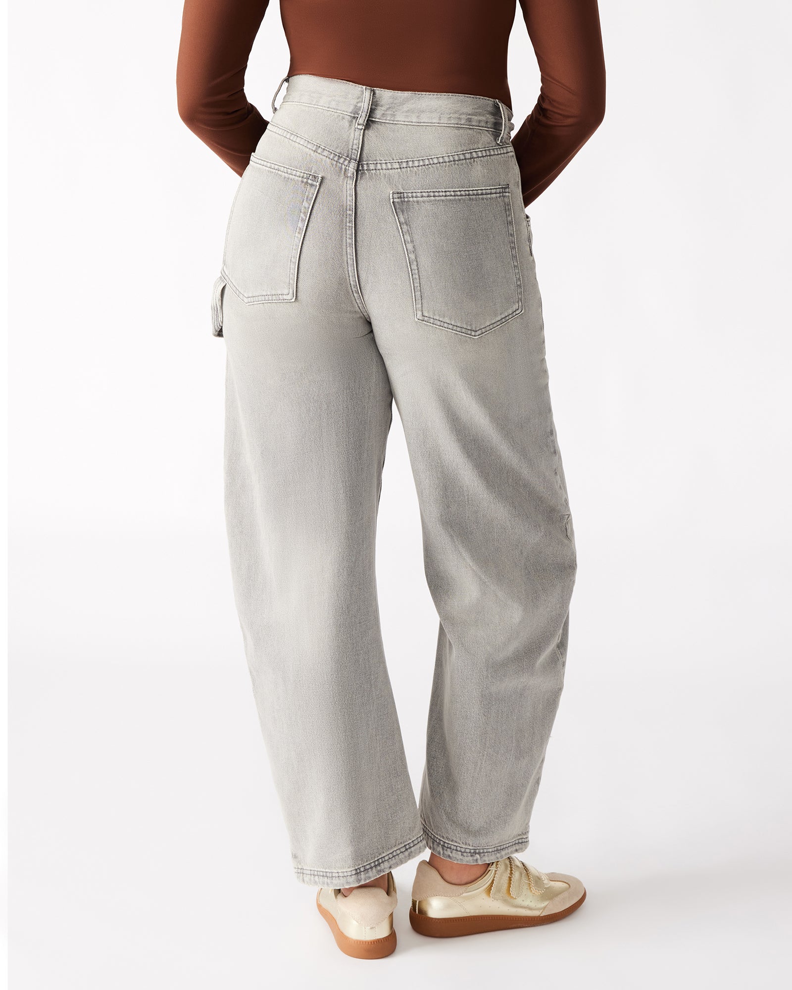 Front view of Hansen light grey barrel leg pants on a model, highlighting the fit.