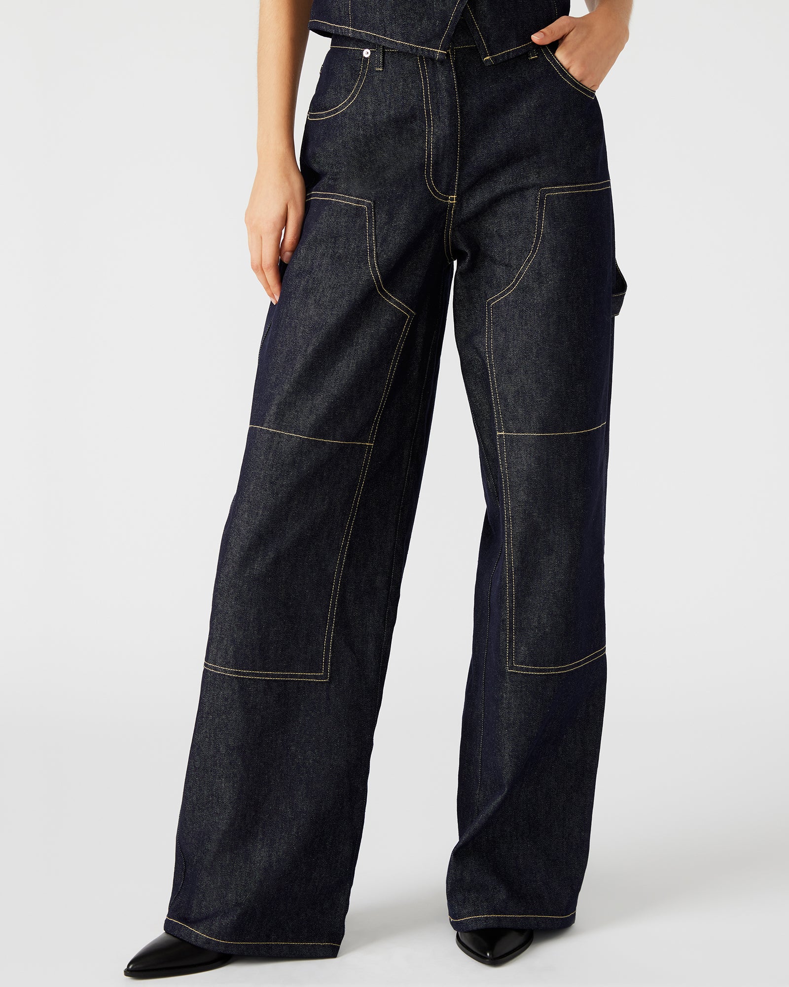 Front view of black wide leg jeans for women styled with a casual top.