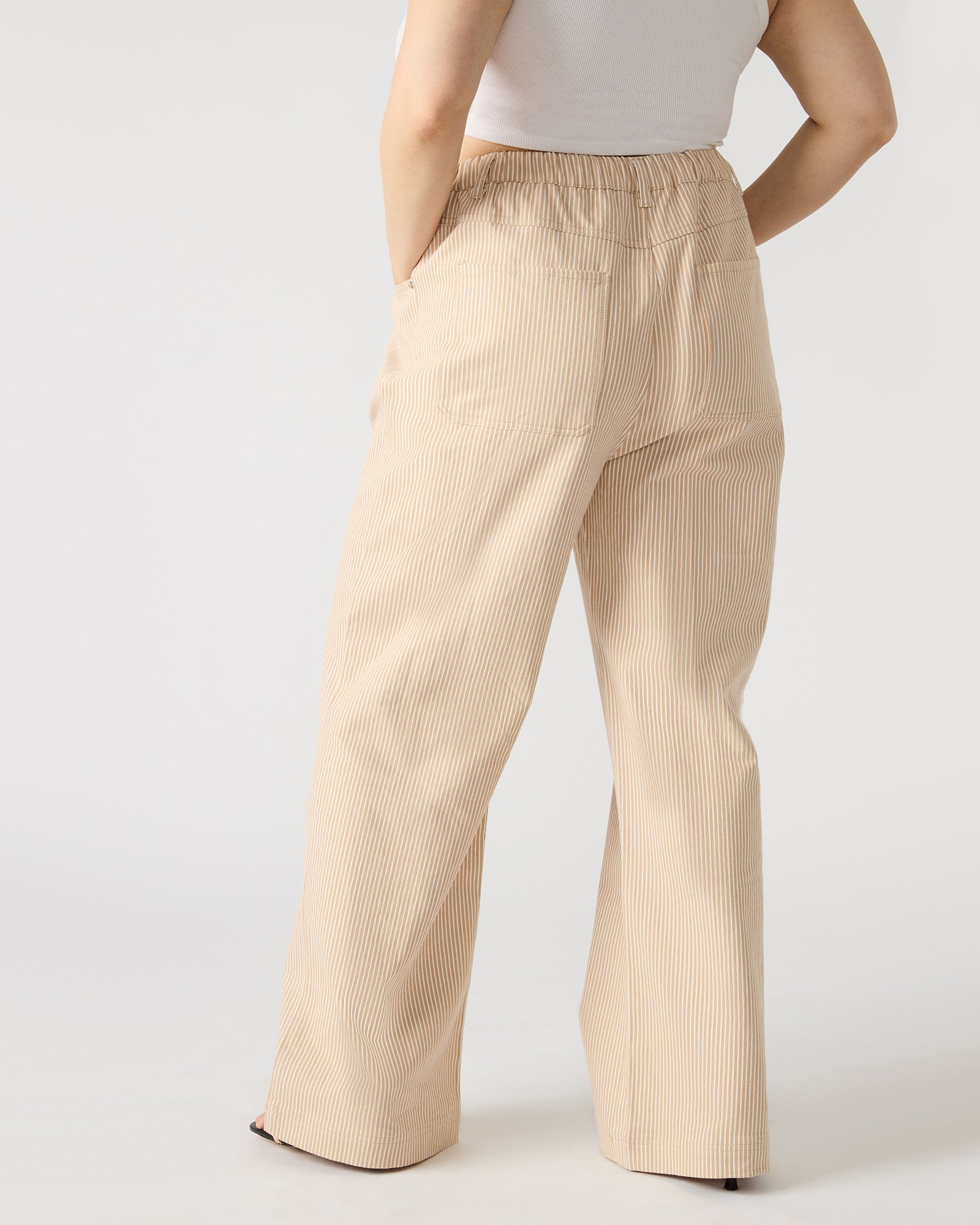 Side angle of wide leg linen pants worn during a casual stroll