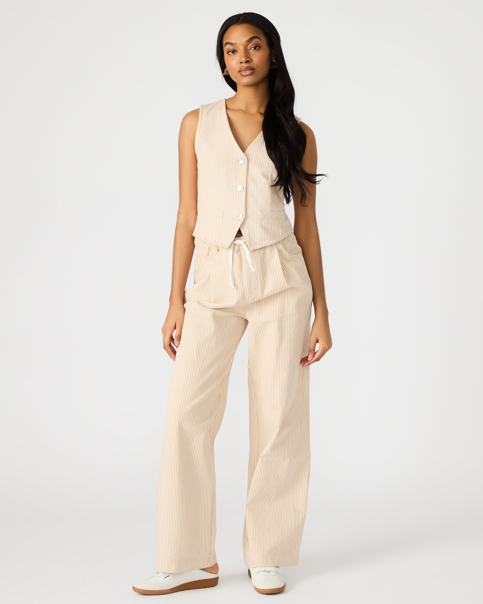 Front view of khaki cotton pants styled with sandals for warm weather days