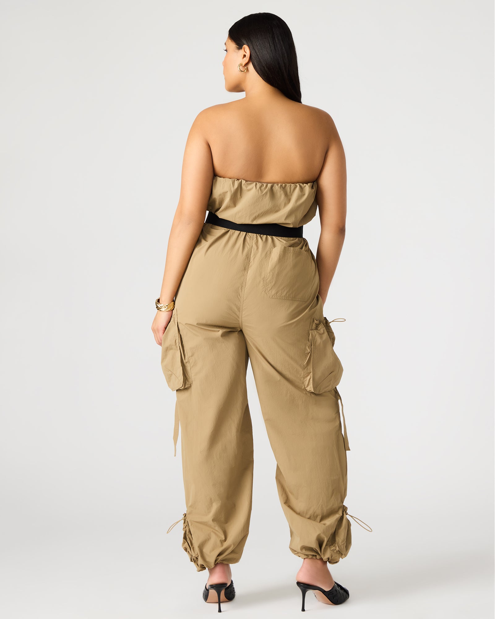 Flat lay of the black strapless jumpsuit with accessories