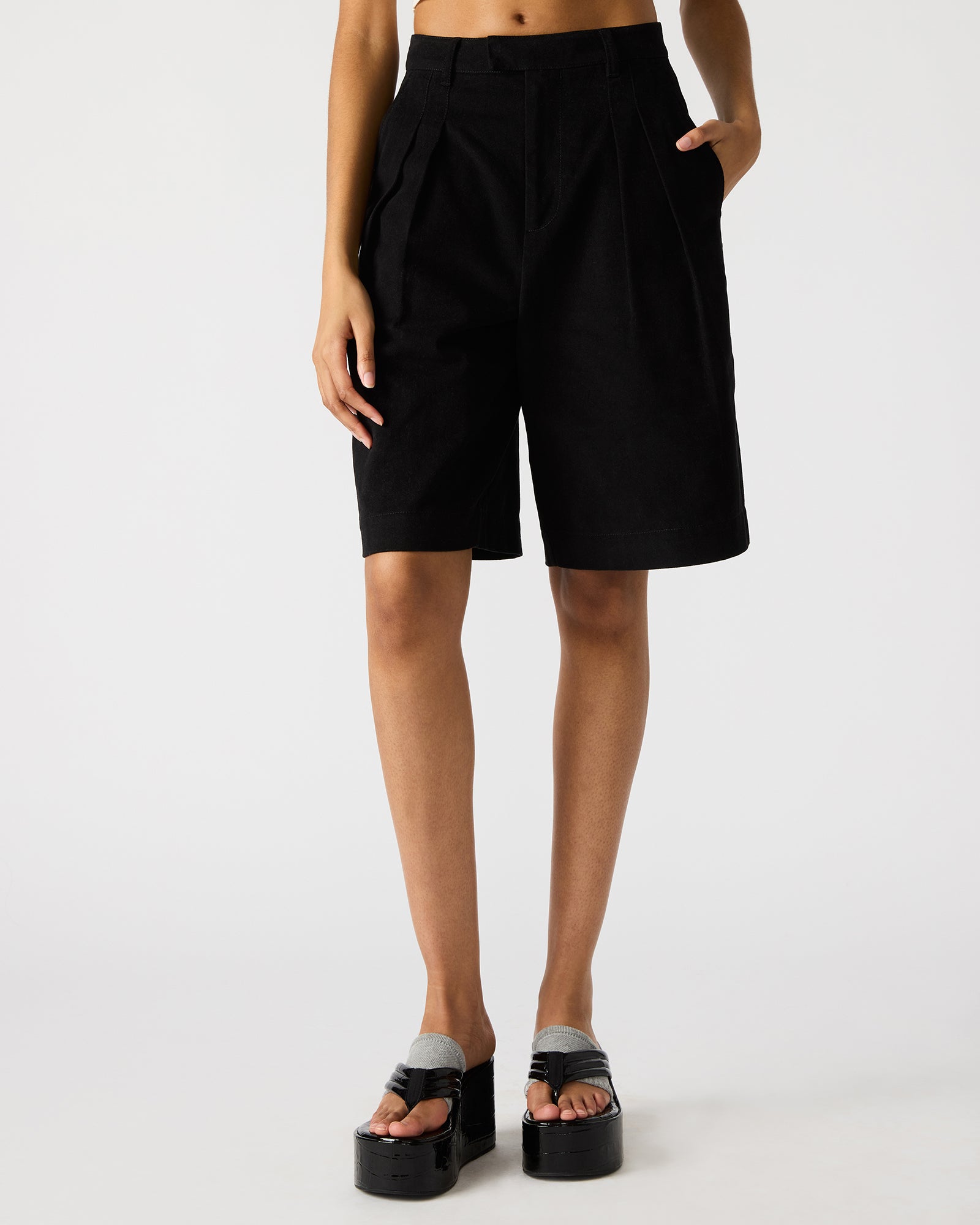 Close-up of mens black shorts showcasing the fabric and functional pockets