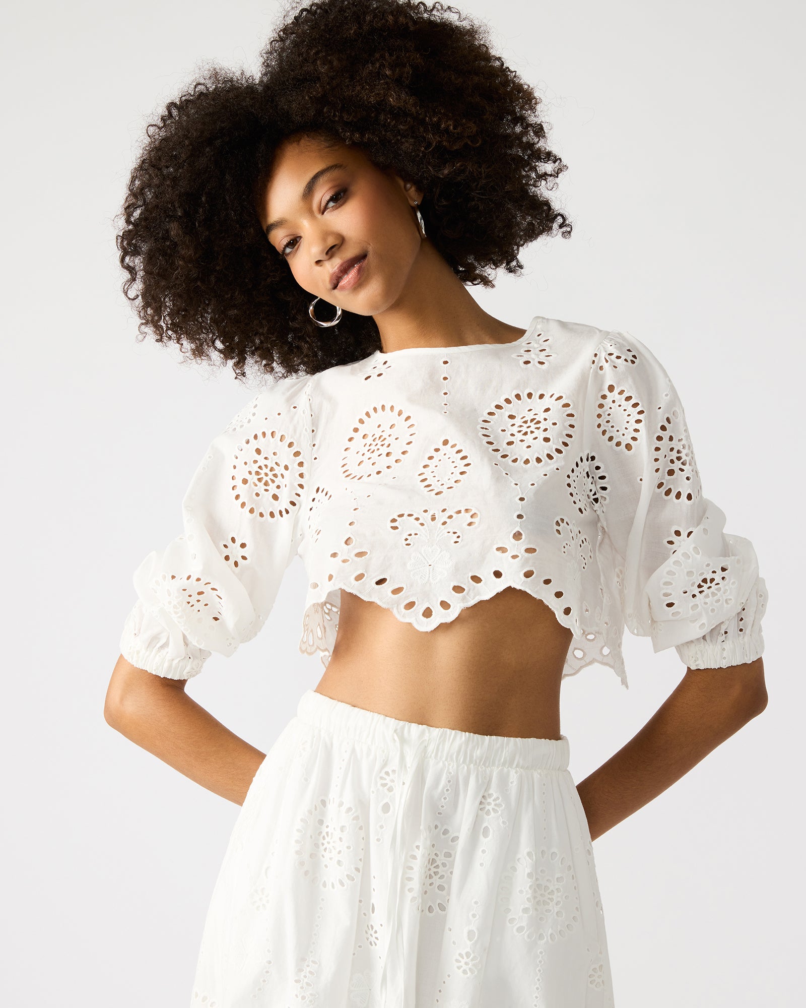 Close-up of eyelet pattern on the crop shirt top, emphasizing craftsmanship