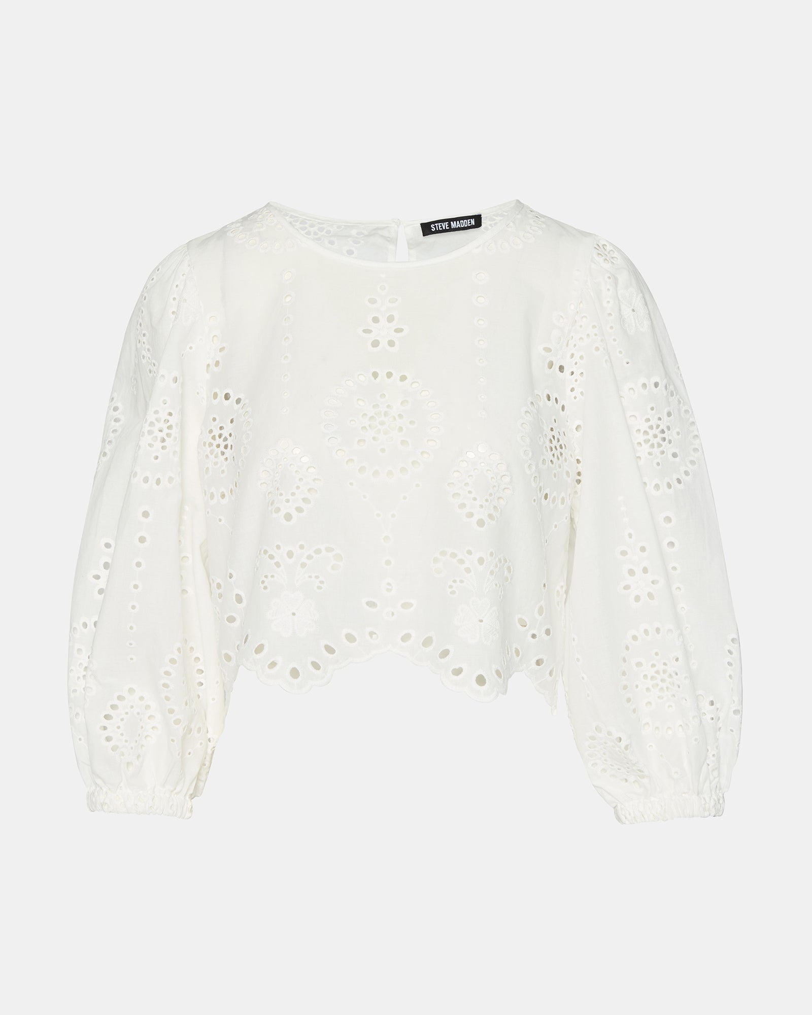 Close-up of eyelet pattern on the crop shirt top, emphasizing craftsmanship