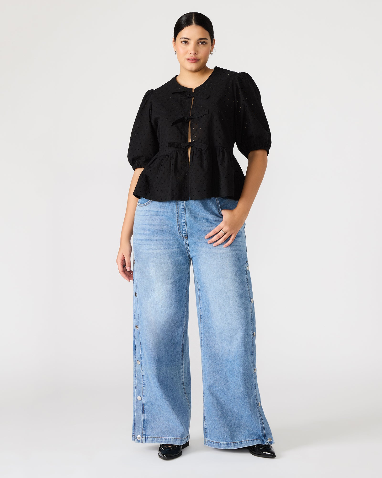 Close-up of the eyelet detailing on the puff sleeve top.