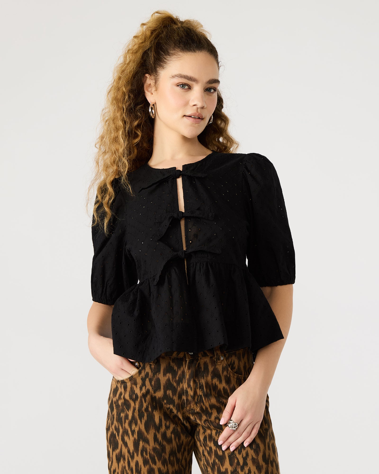 Close-up of the eyelet detailing on the puff sleeve top.