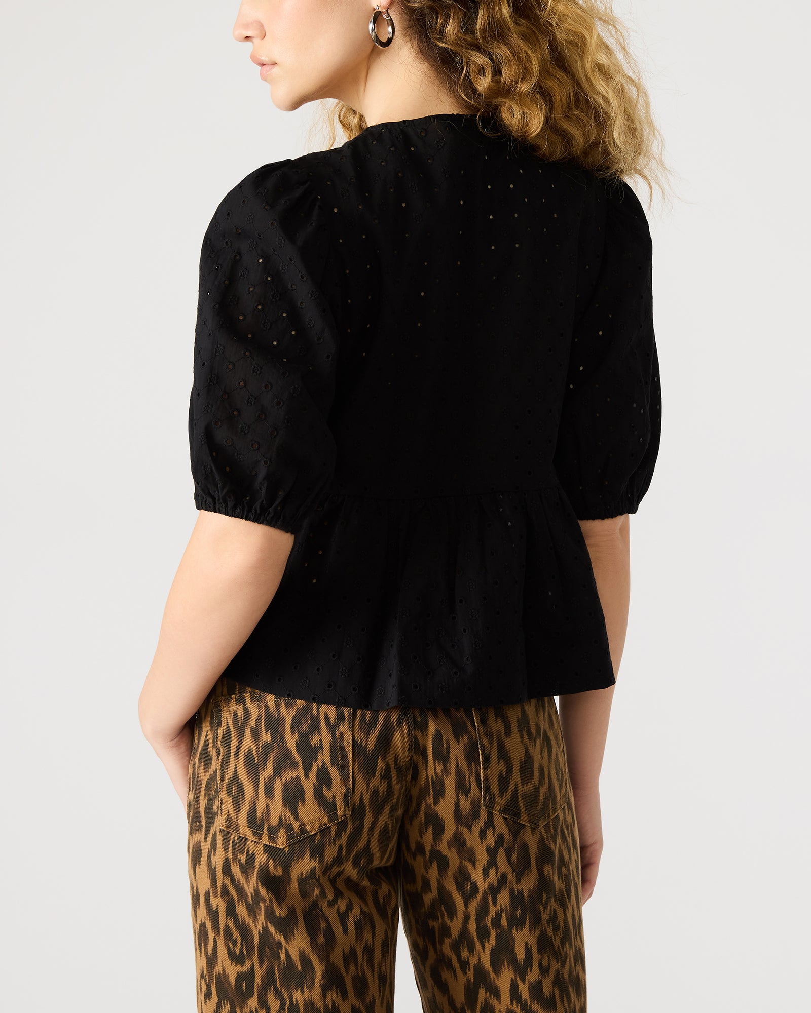 Side view showcasing the tie at the front of the black top.