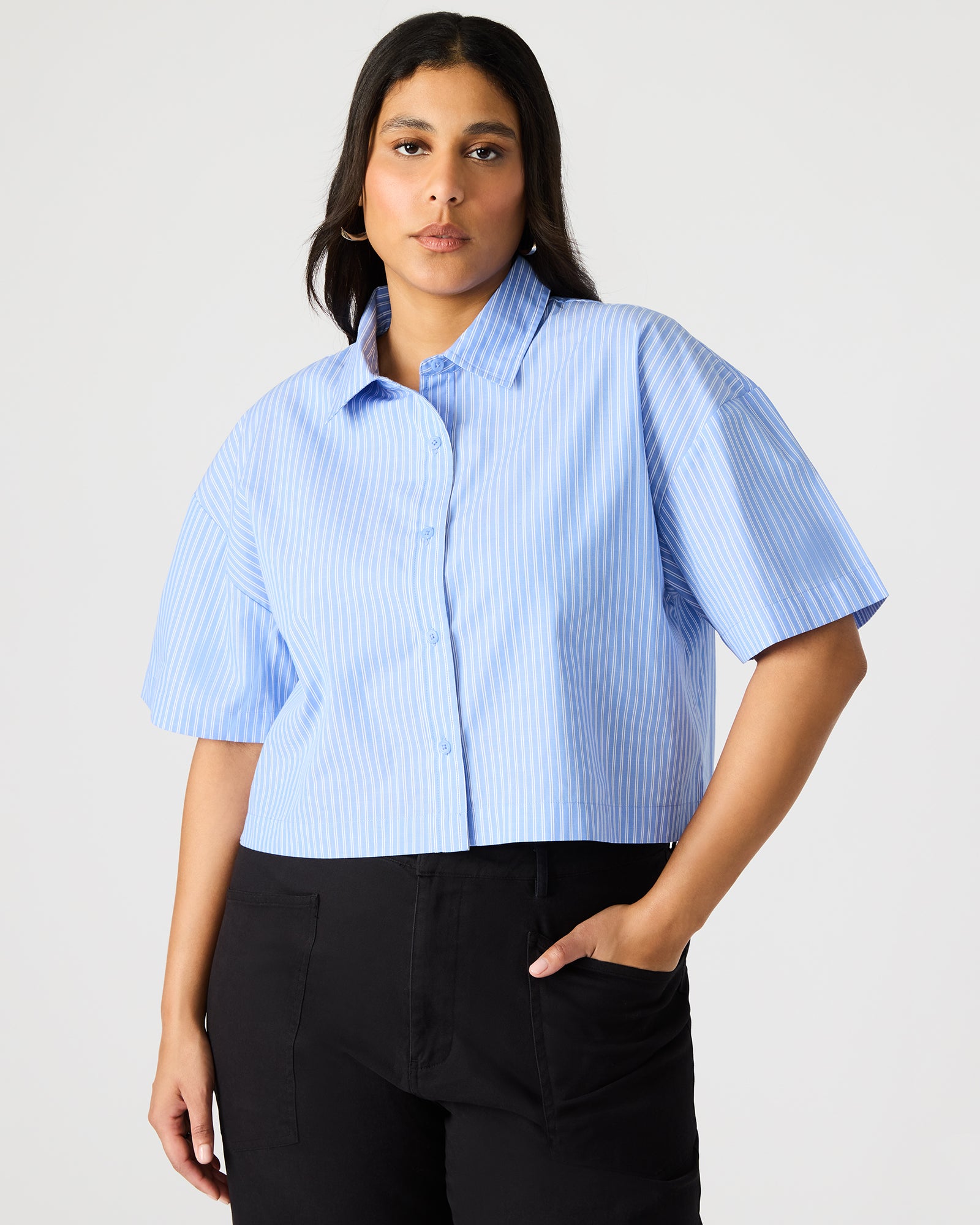 Tula striped blouse worn by a model in a casual urban setting