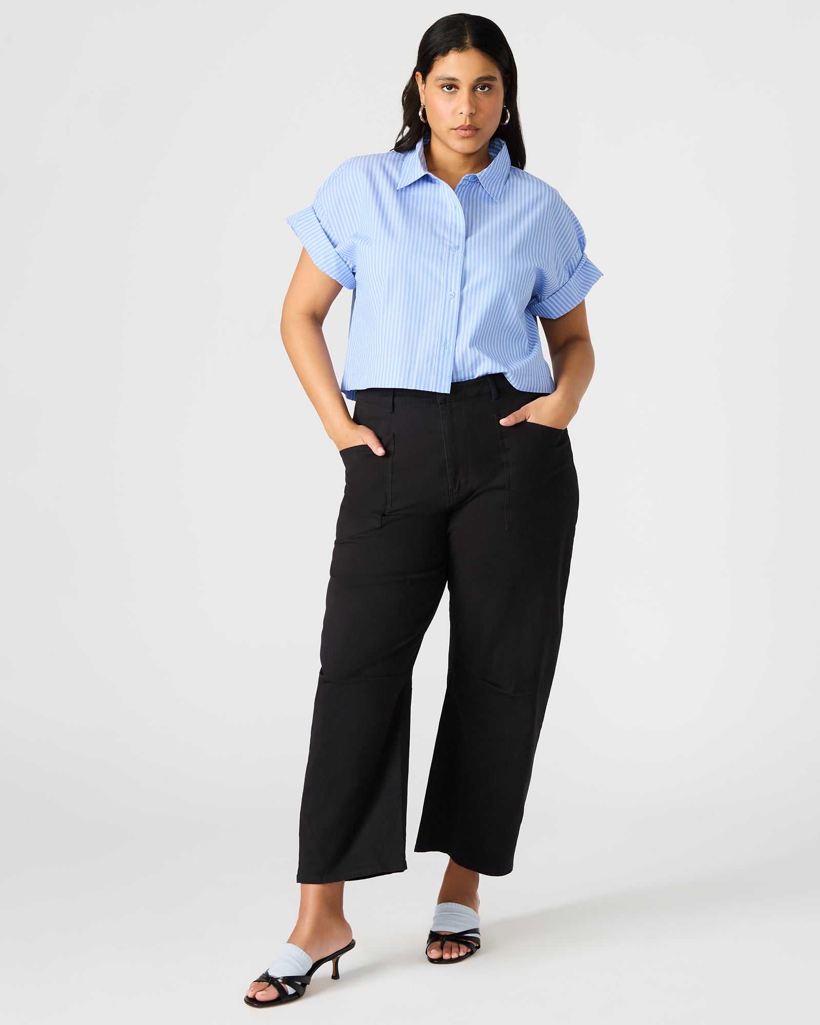 Blue and white striped shirt styled with dark denim for a polished look