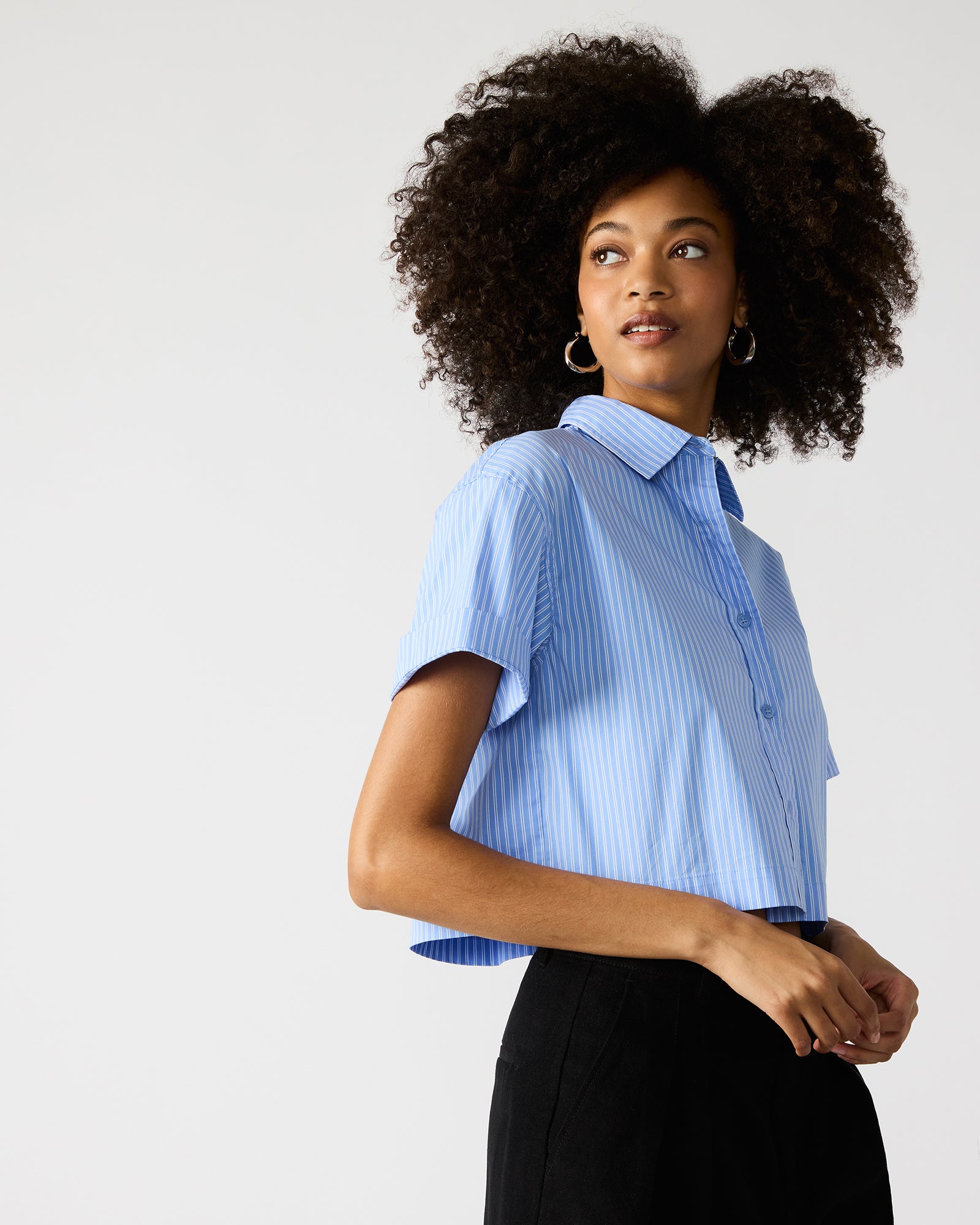 Blue and white striped shirt styled with dark denim for a polished look