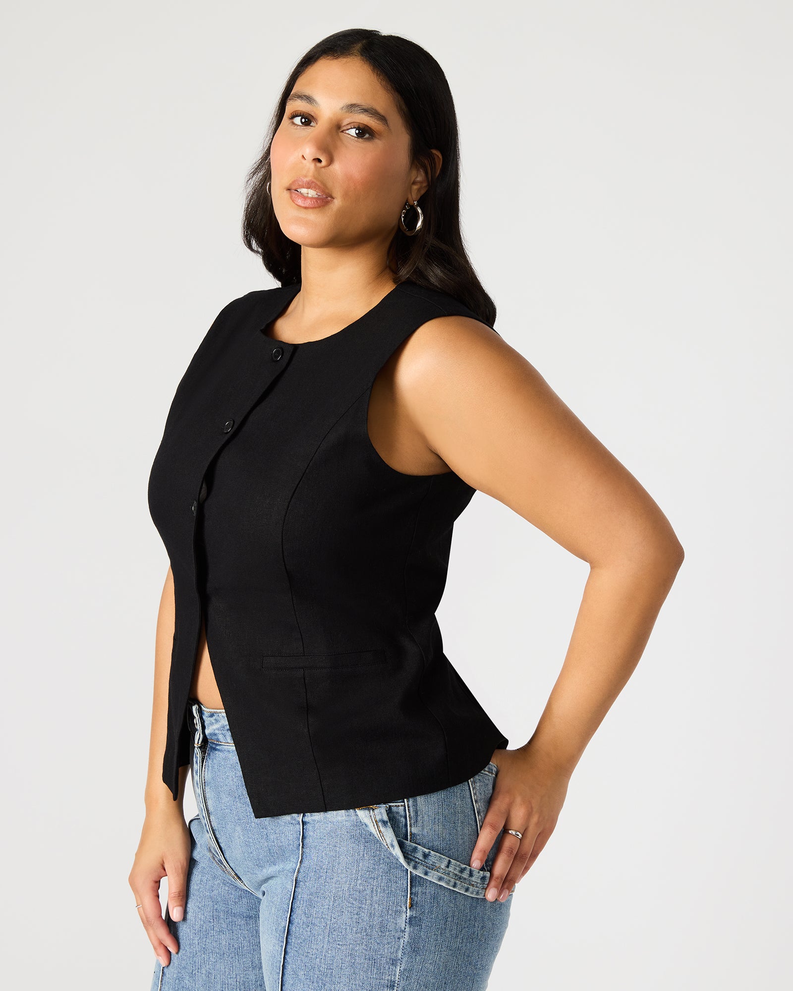 Model wearing Wesley black vest top styled with denim jeans