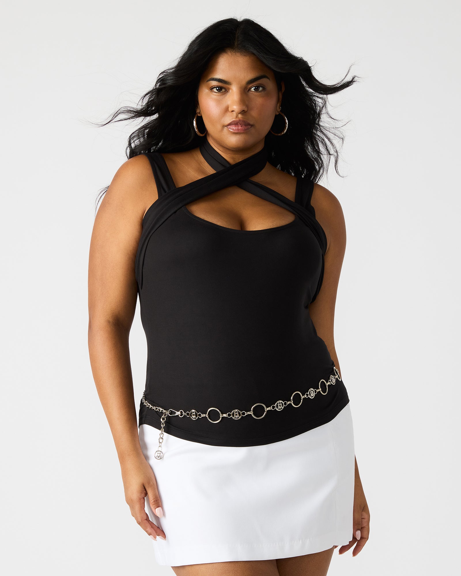 Model showcasing the halter top with high-waisted jeans
