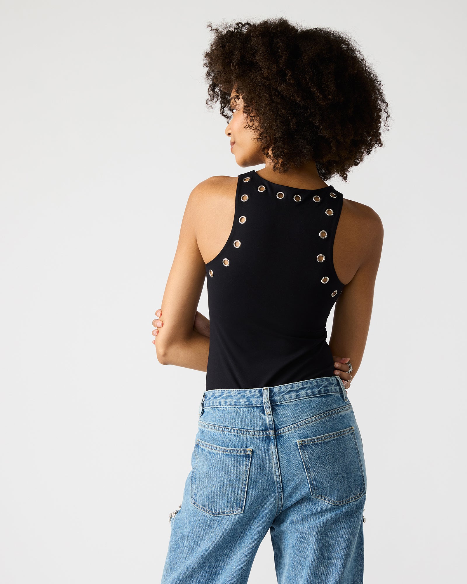 Nico black bodysuit worn with high-waisted trousers for a polished look.