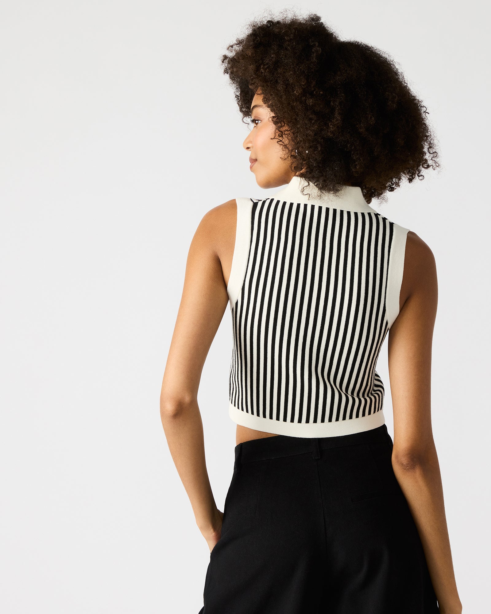 Side angle of the black sweater vest showing the collared neckline and stripe pattern
