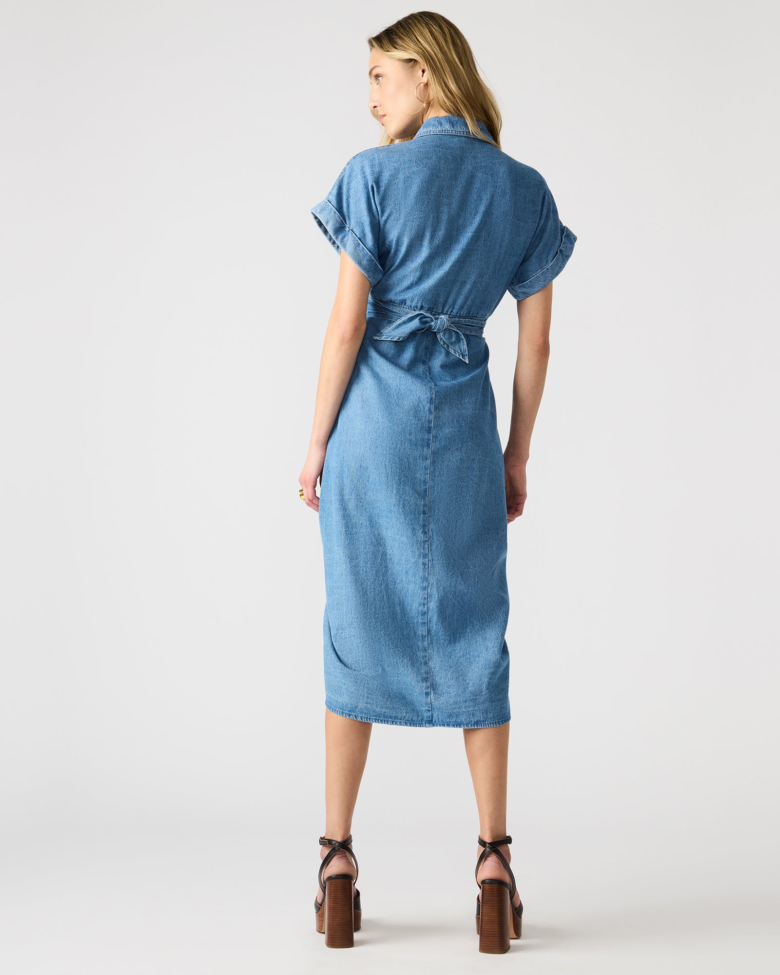 Front view of denim dress styled with flats, ideal for daily city wear