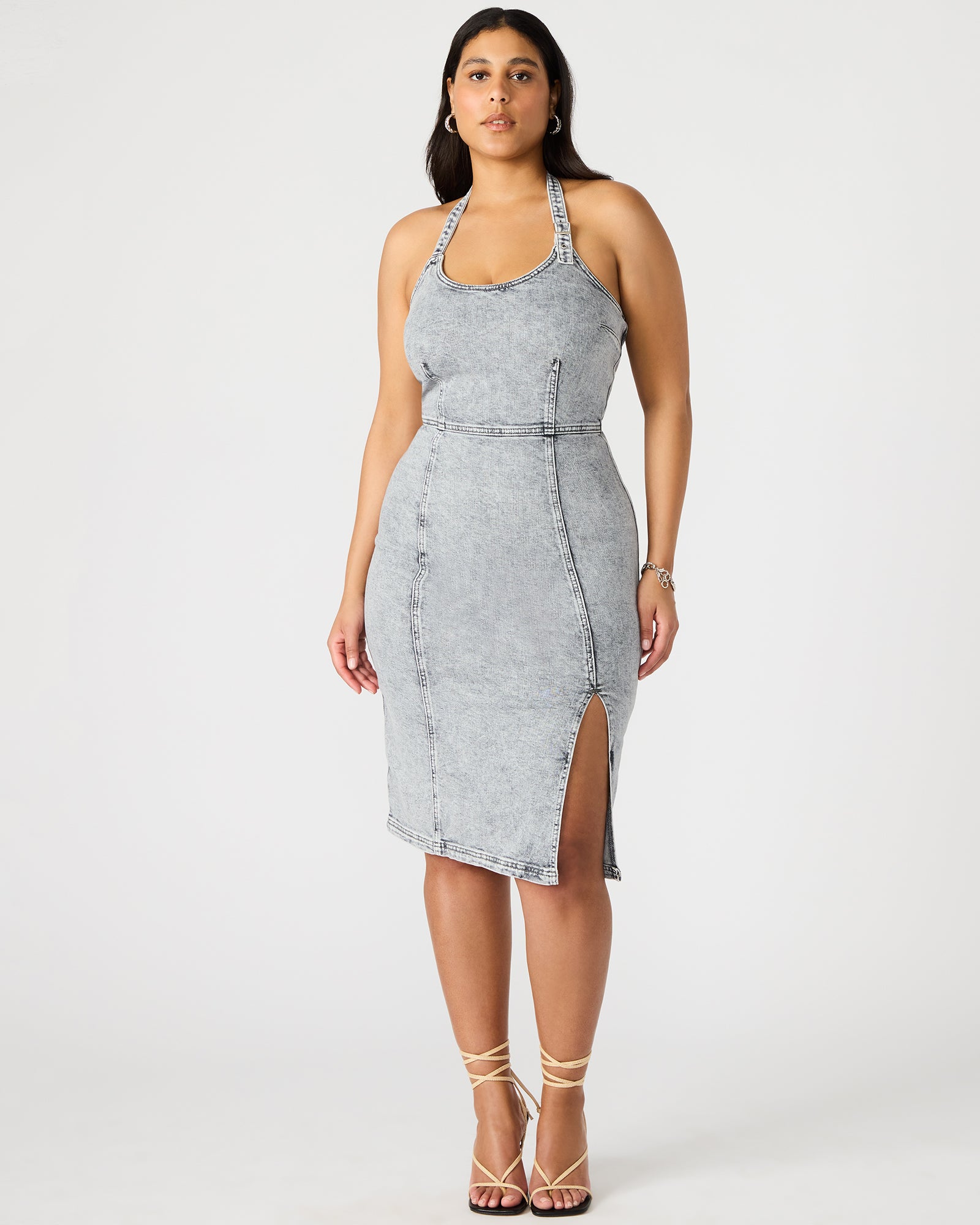 Front view of the light grey denim dress on a model, highlighting the midi length