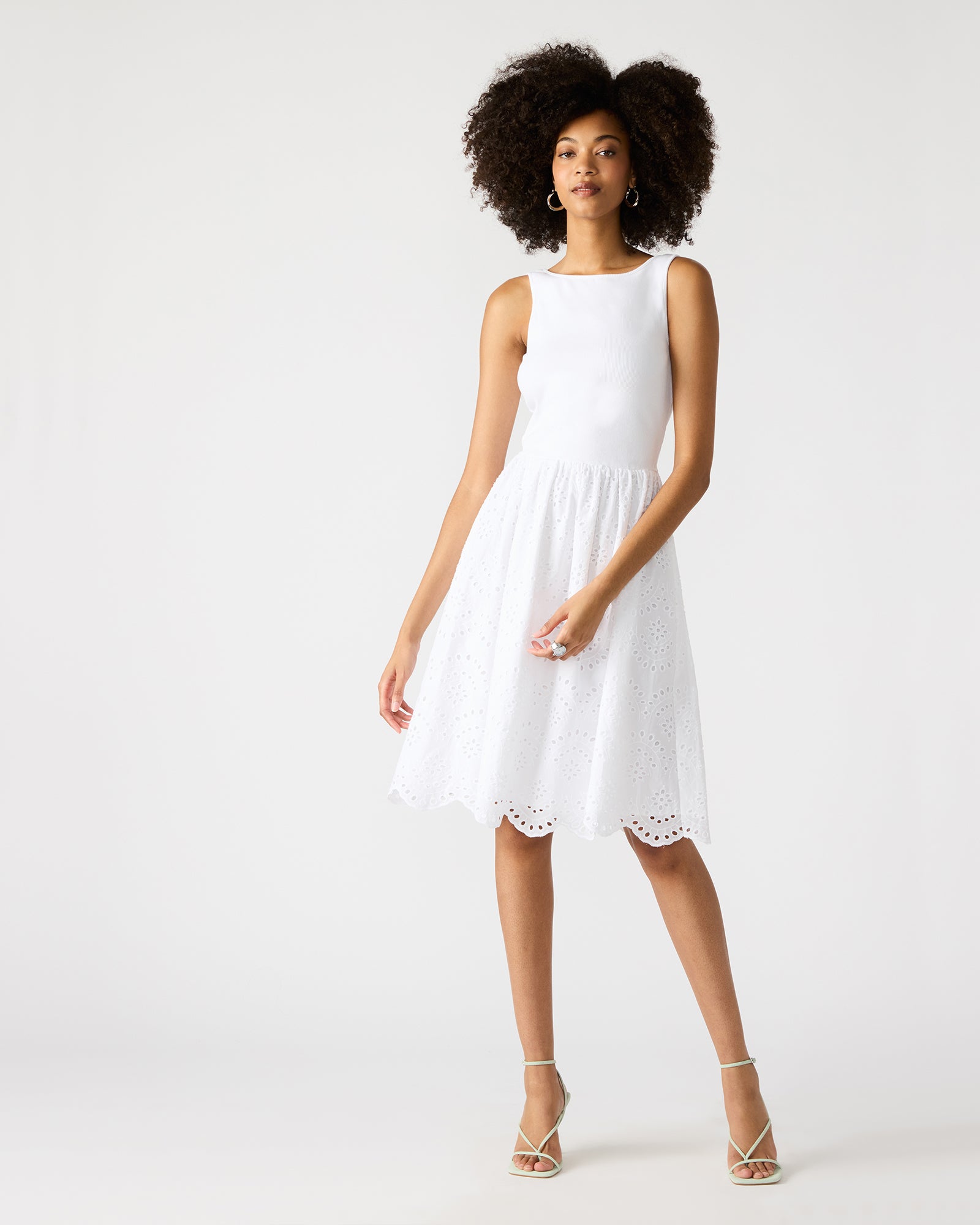 Side angle of sleeveless dress showcasing eyelet details.