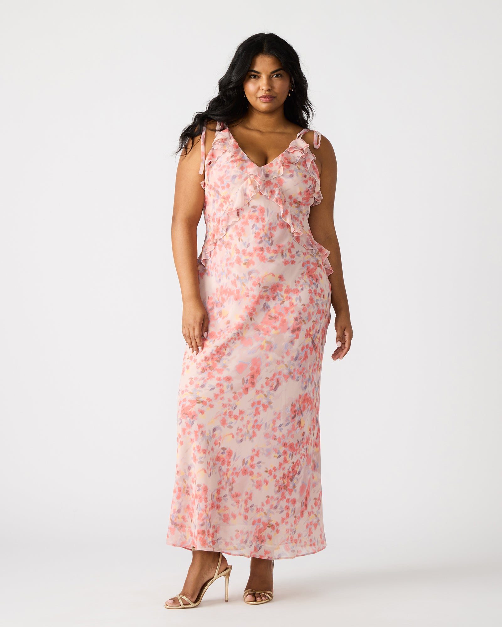 Front view of a lavender ruffle maxi dress on a model at a garden party.