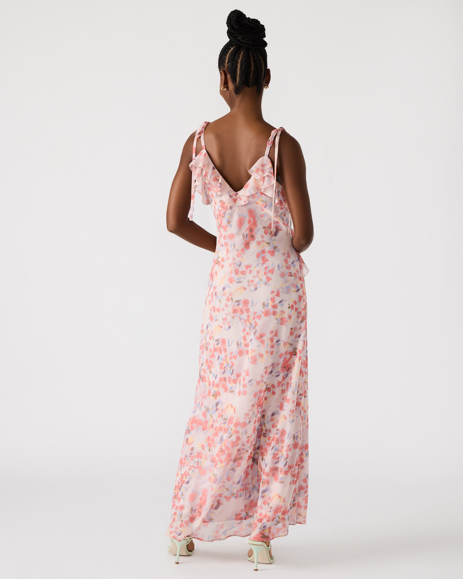 Front view of a lavender ruffle maxi dress on a model at a garden party.