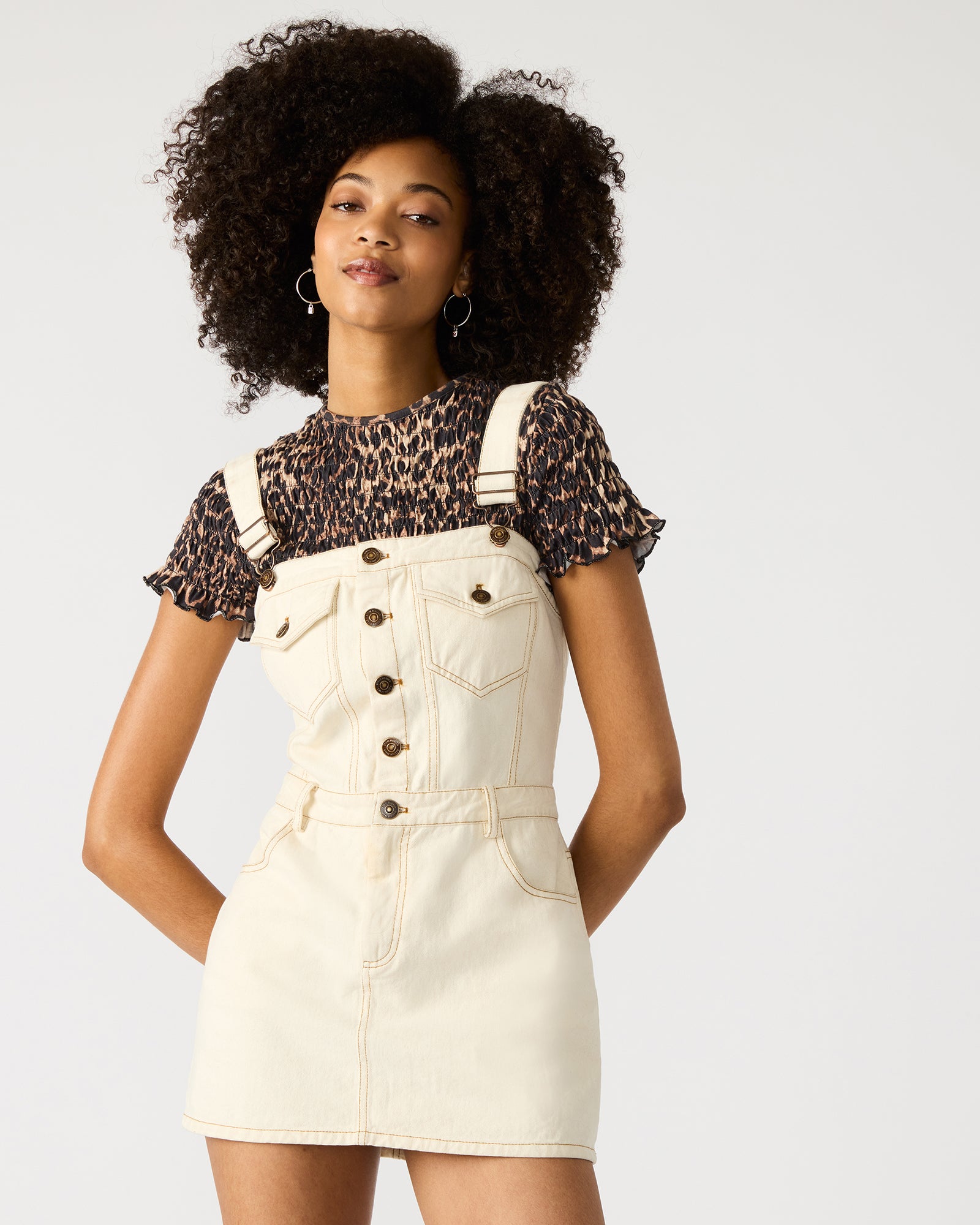 Side angle showing functional pockets on the denim mini dress