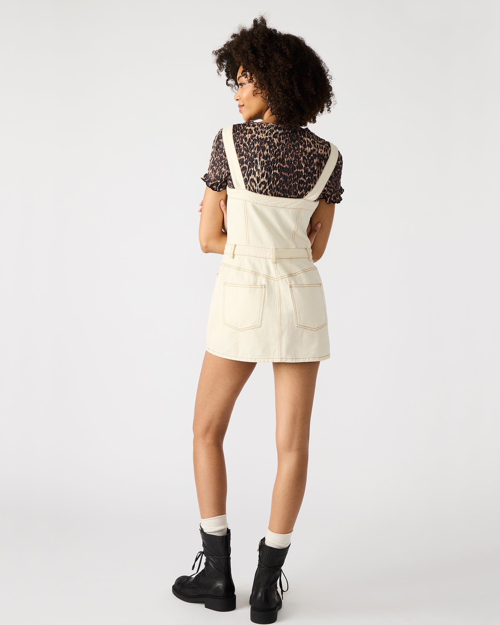 Model outdoors in creamwash sleeveless dress mini dresses look, styled for summer