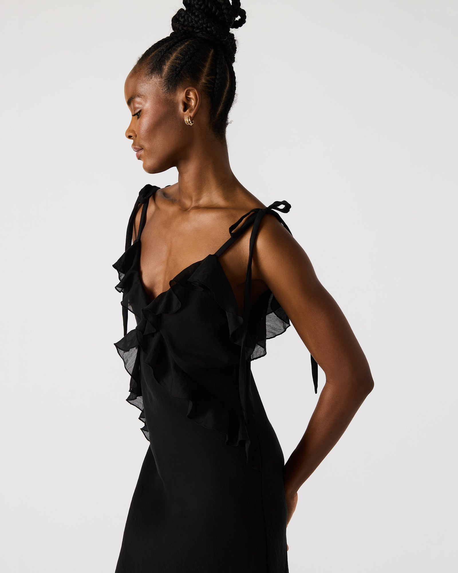 Close-up of black maxi dress ruffle detail neckline, suited for evening parties