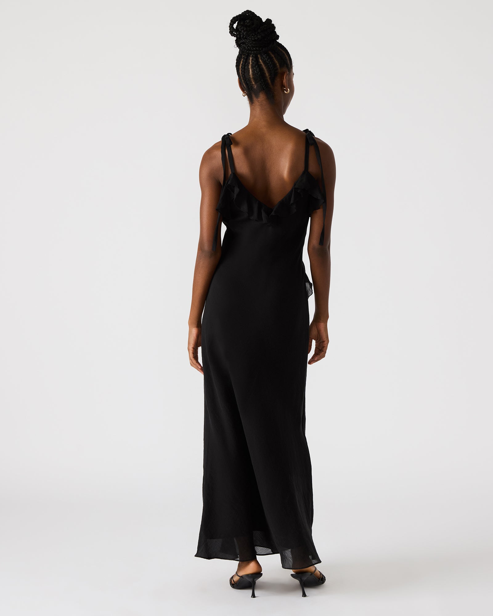 Front view of black lace maxi dress styled with heels, worn at rooftop event