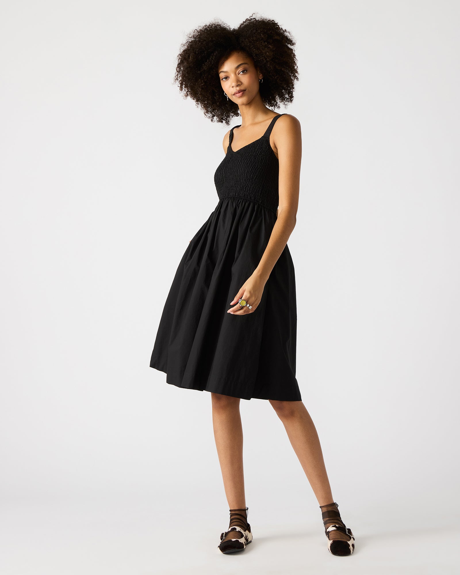 Back view of the black mini dress highlighting adjustable straps
