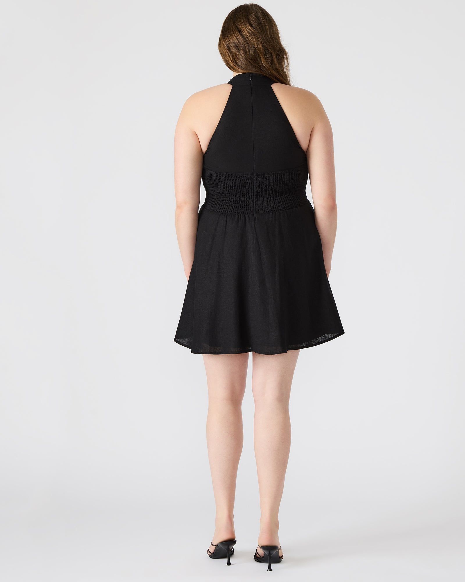 Front view of Kosta black halter dress on model