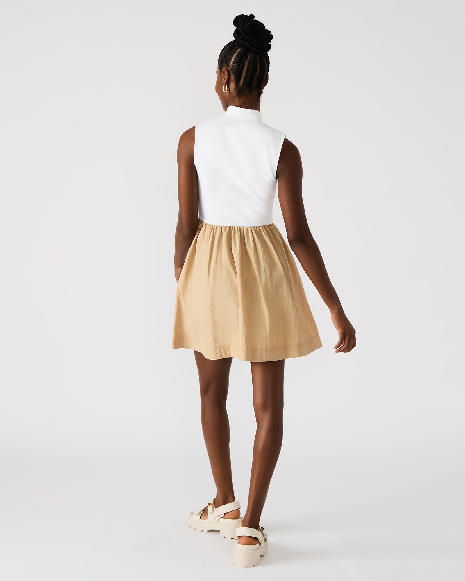 Detail shot of quarter zip dress showing fabric texture and flowy skirt in motion.
